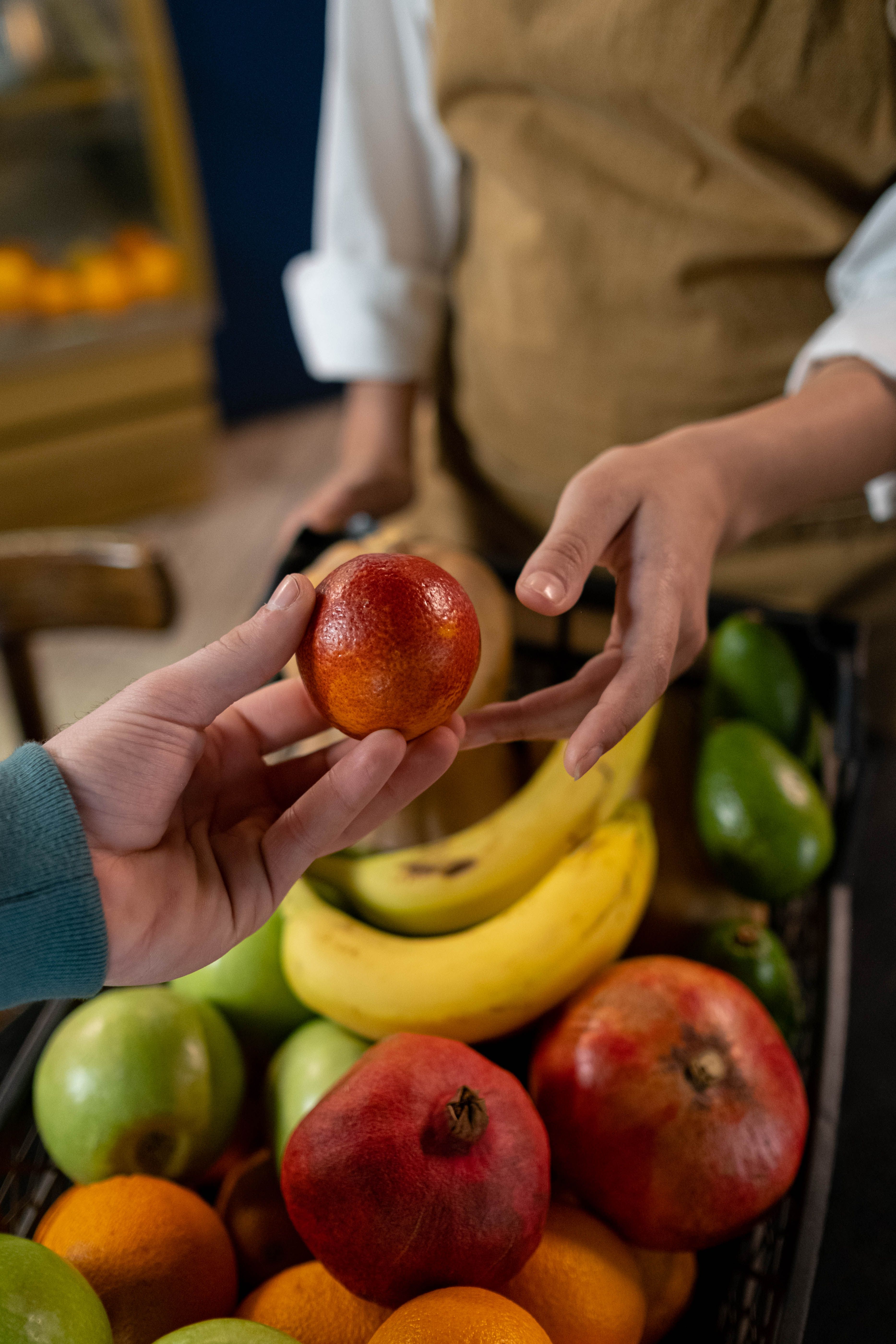 Fruit changing hands between two people