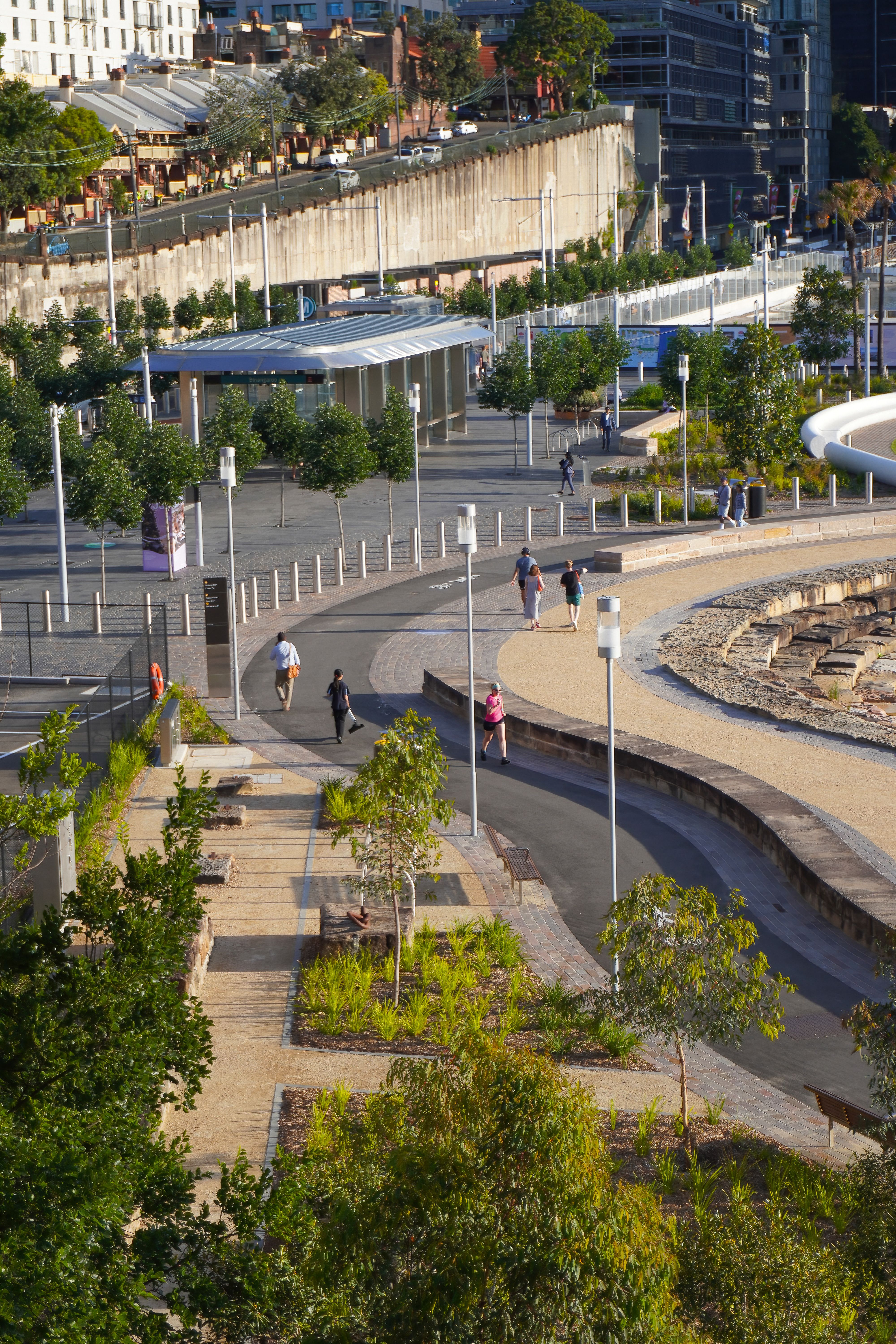 An active public plaza with clear paths, lighting, planting and broad sightlines