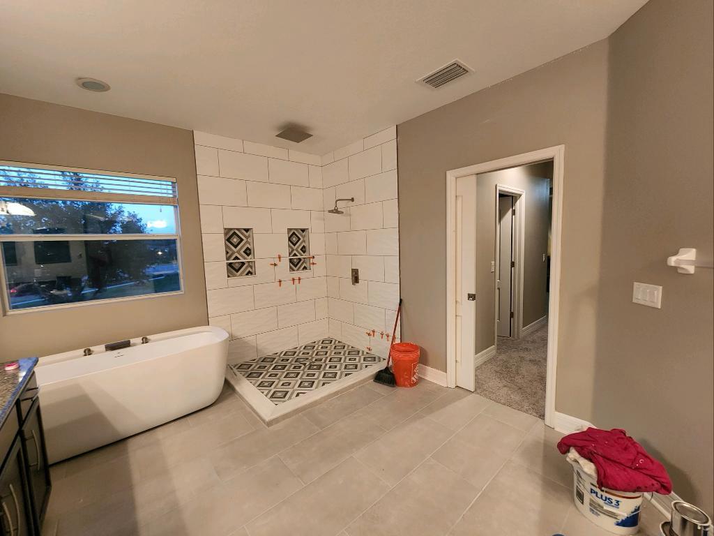 Master bath with freestanding tub and shower