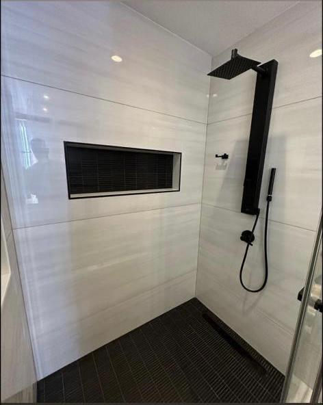 Modern walk-in shower with black fixtures