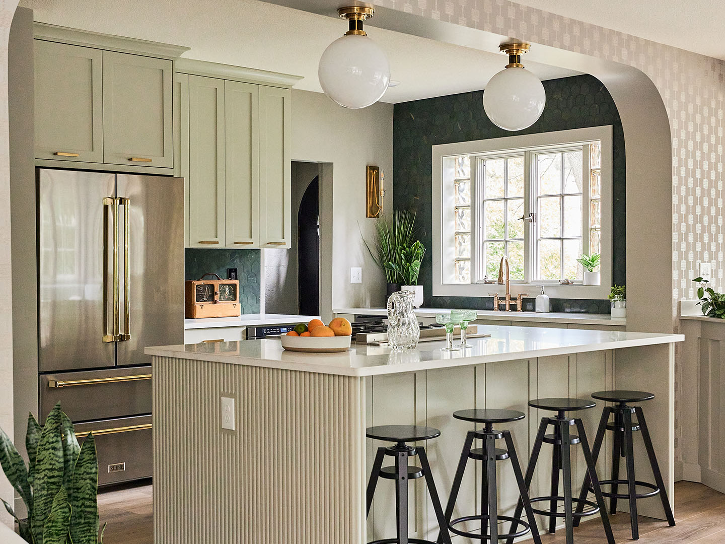 Sage green cabinets with white island