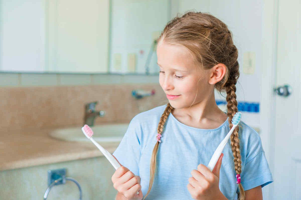 child-toothbrush-poor-technique-demonstrating-kids-brushing-mistakes-bad-dental-habits-kids-oral-hygiene-mistakes
