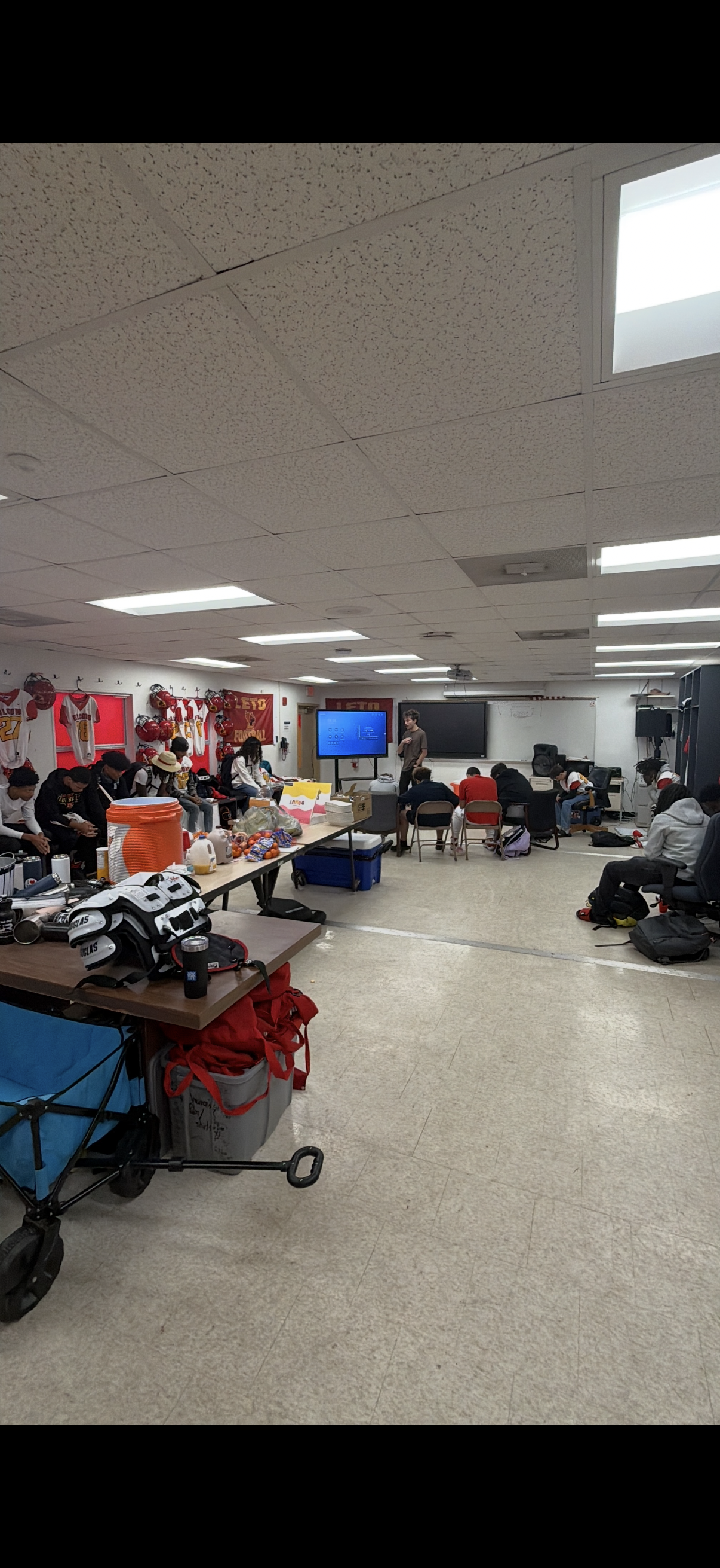 High school football team gathered for a River Youth team visit in Tampa