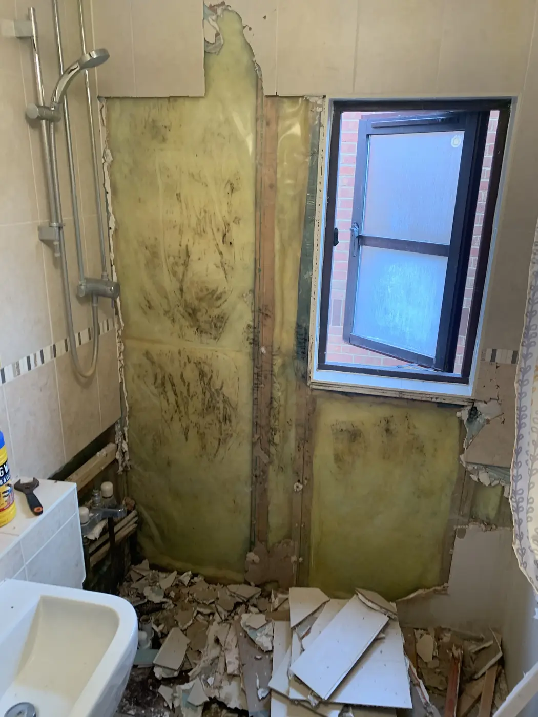 Mouldy wall stripped out in an Oxford bathroom