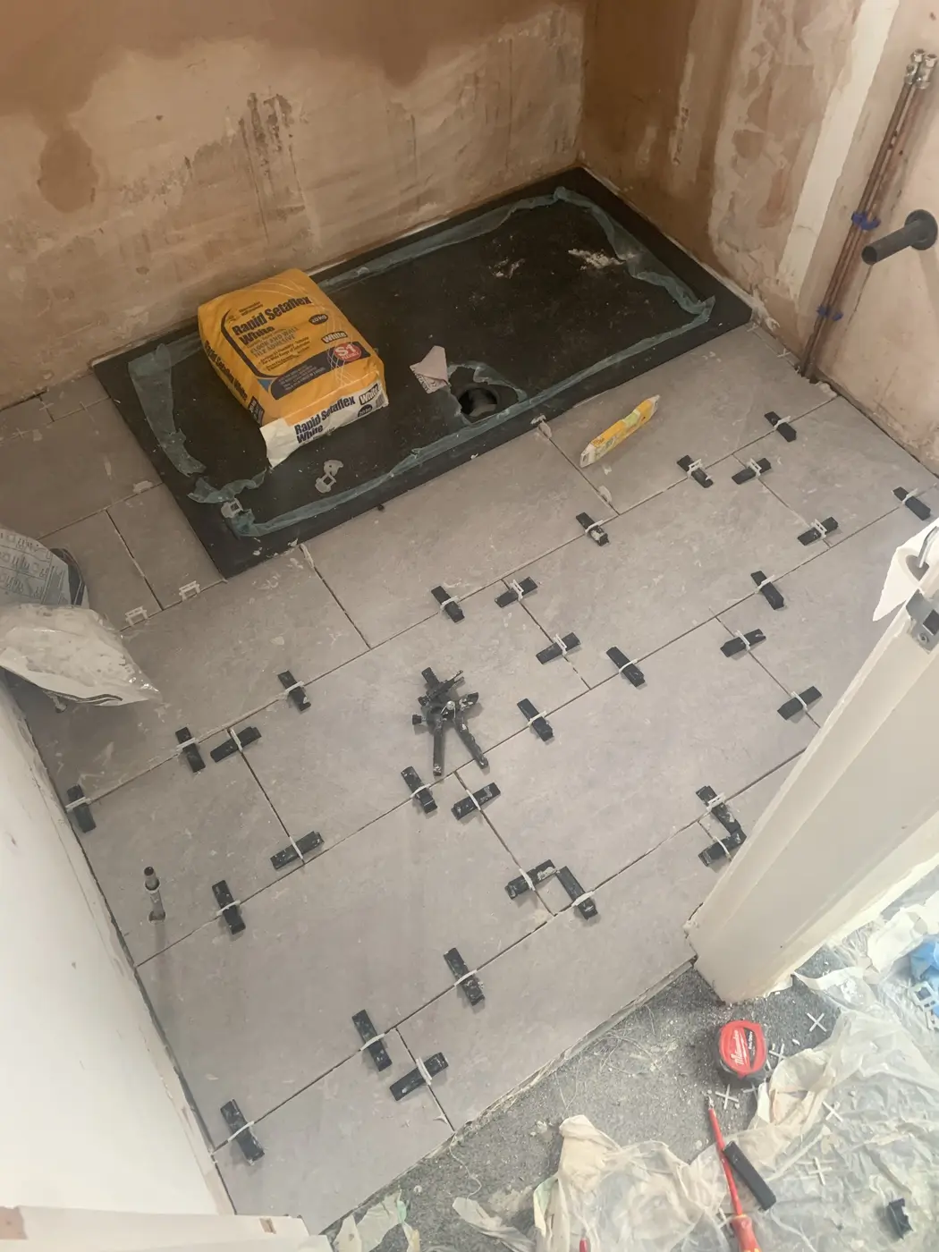 Shower tray in and floor tiles levelled in an Oxford bathroom