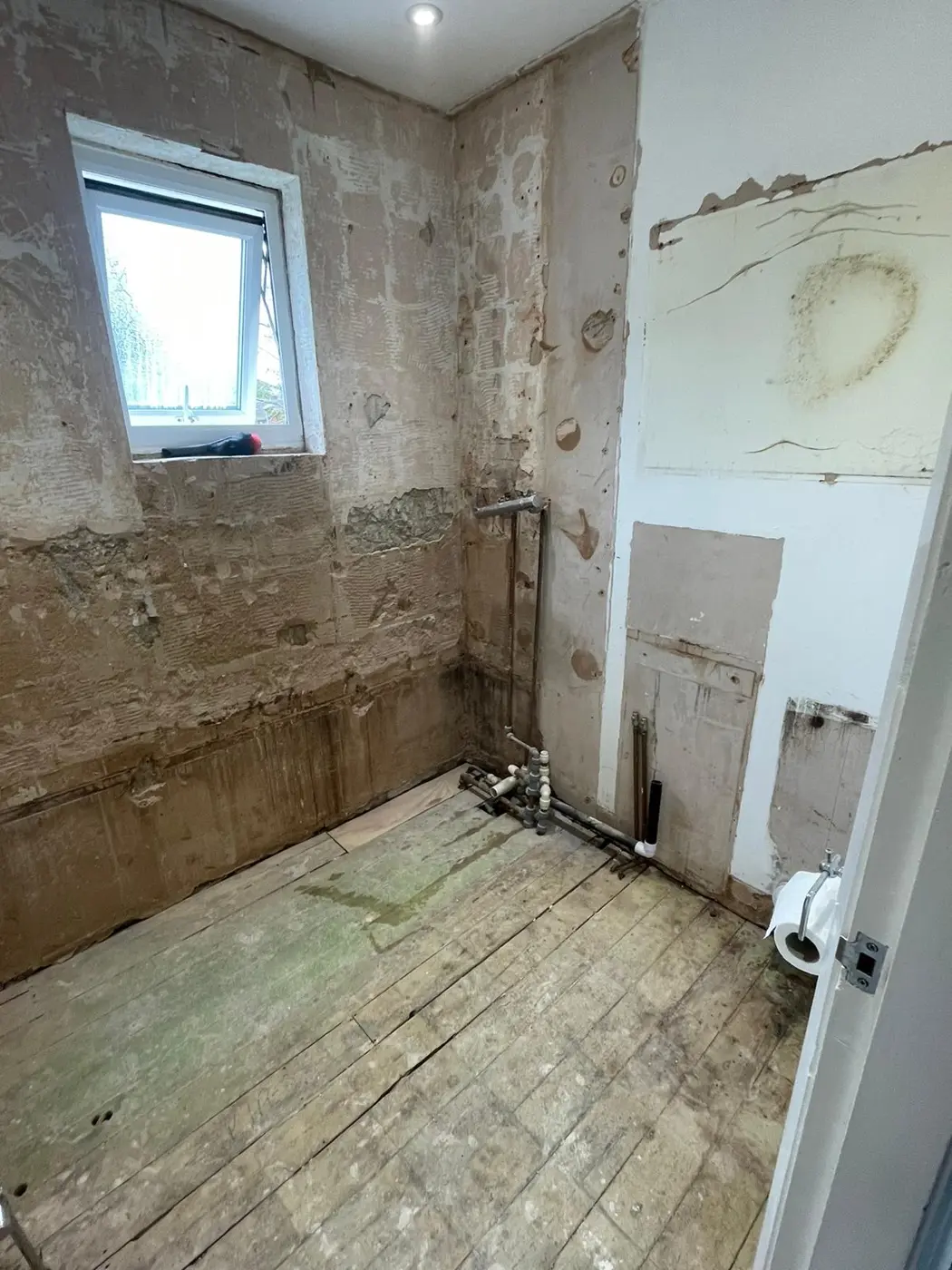 Oxford bathroom stripped back to the walls and pipework