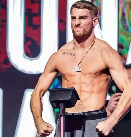 A coached fighter at a stage weigh-in