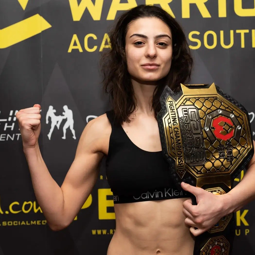 A coached fighter with a Cage Warriors belt