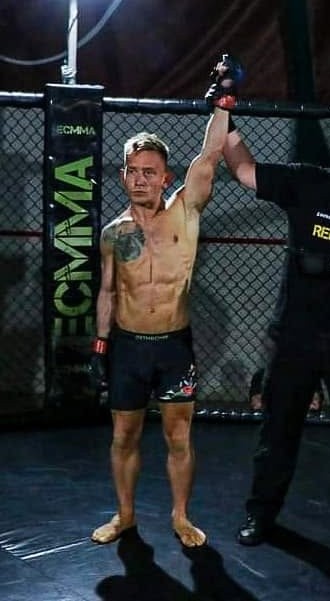 Tom having his hand raised after an MMA win