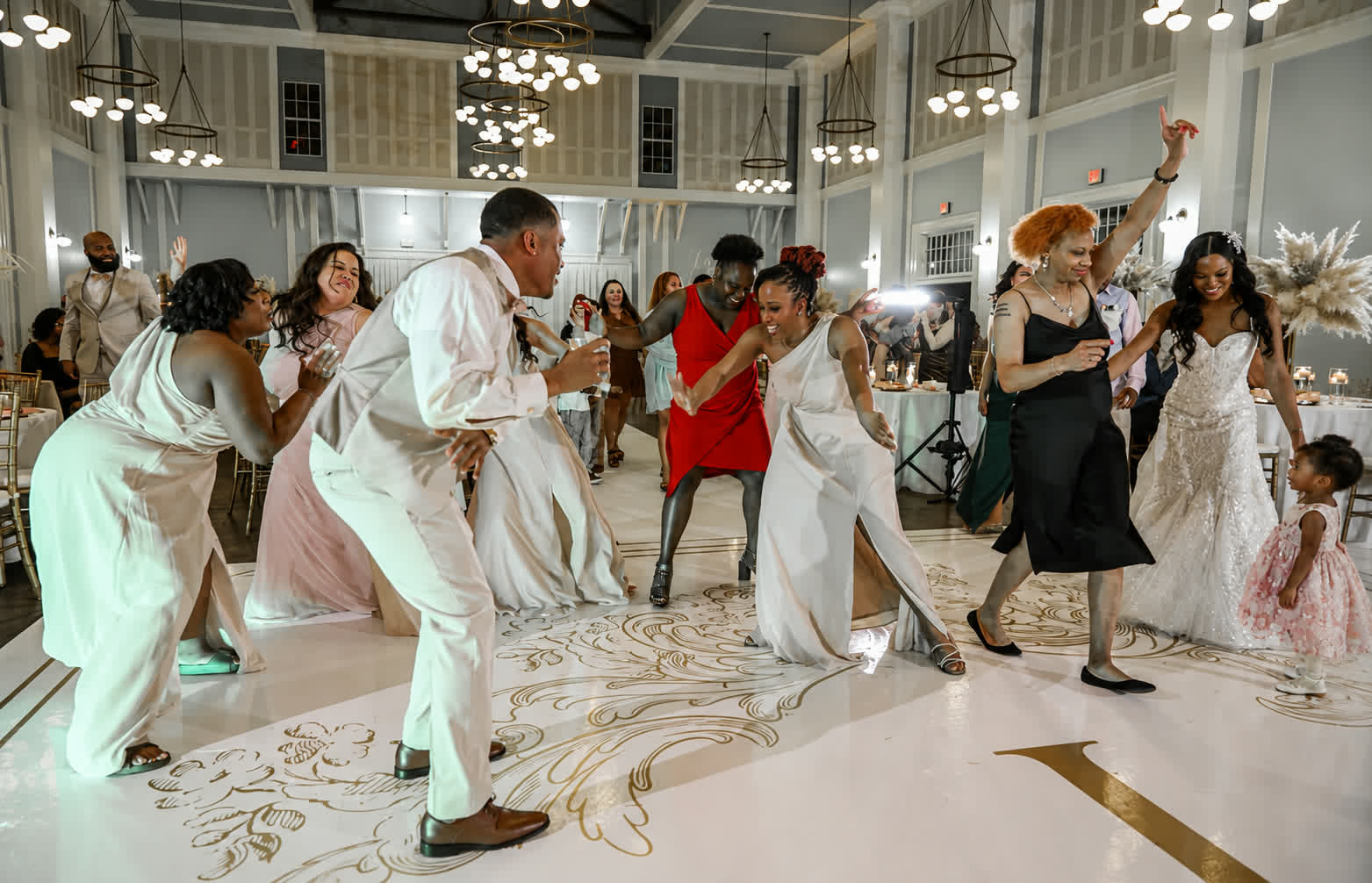 Guests dancing in a bright reception hall at a GrizzLee Entertainment event