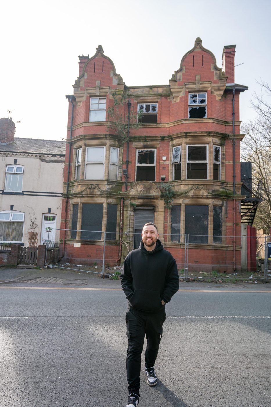 Alex Marsh standing outside the former hotel in Wigan, before conversion