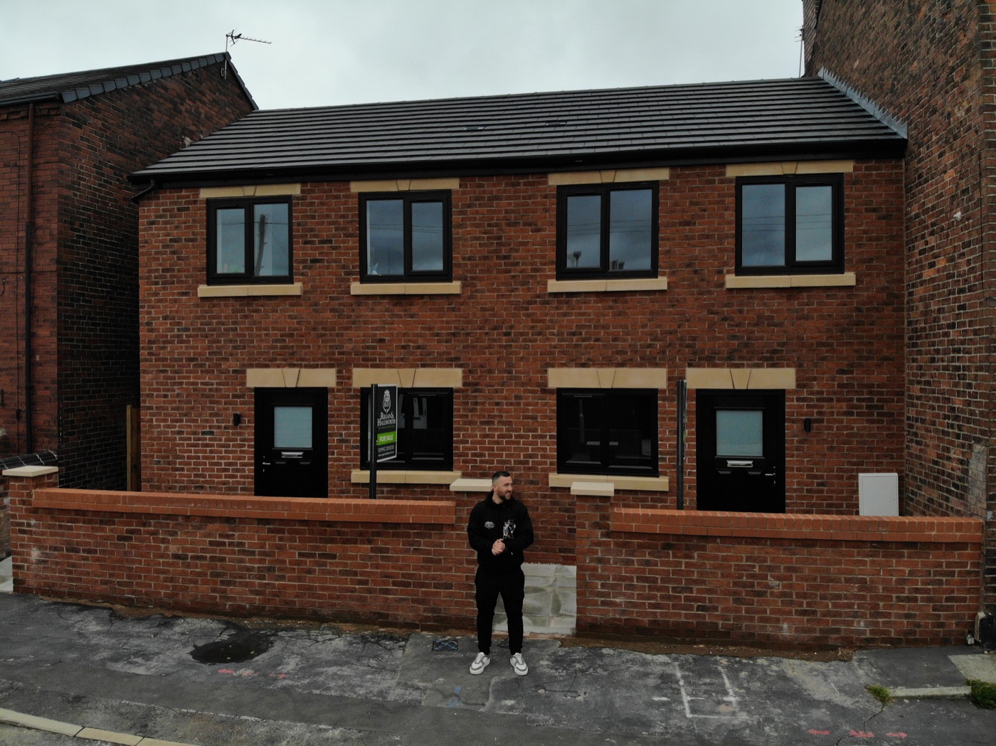 Alex in front of the two completed new-build homes at 29 and 31 Chatsworth Street