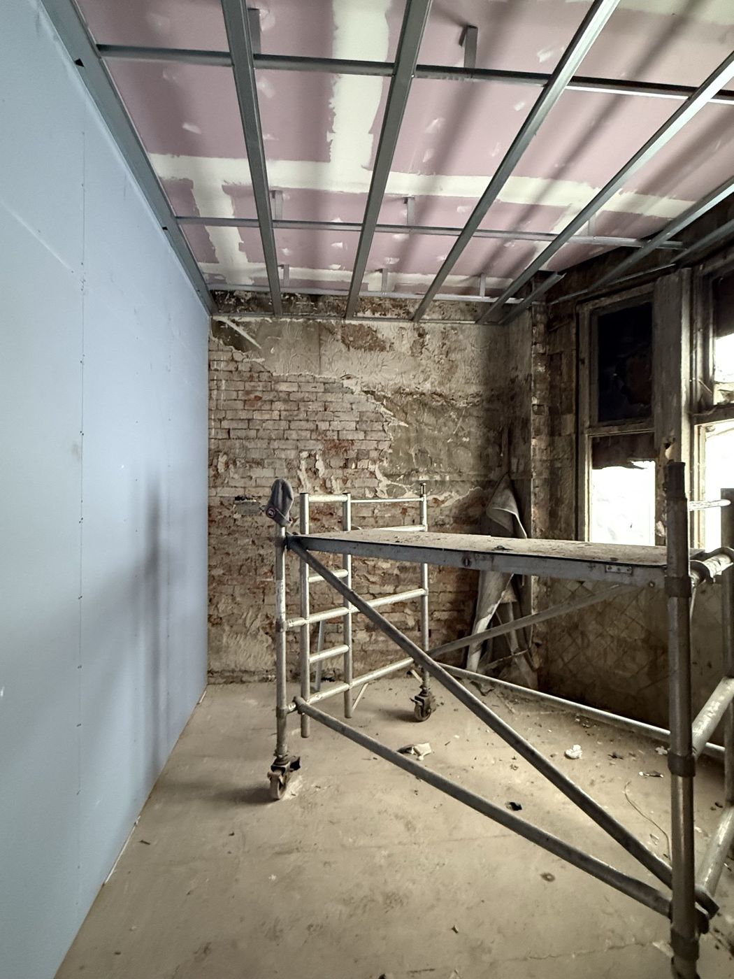 Ceiling framework and scaffold tower in an upper room