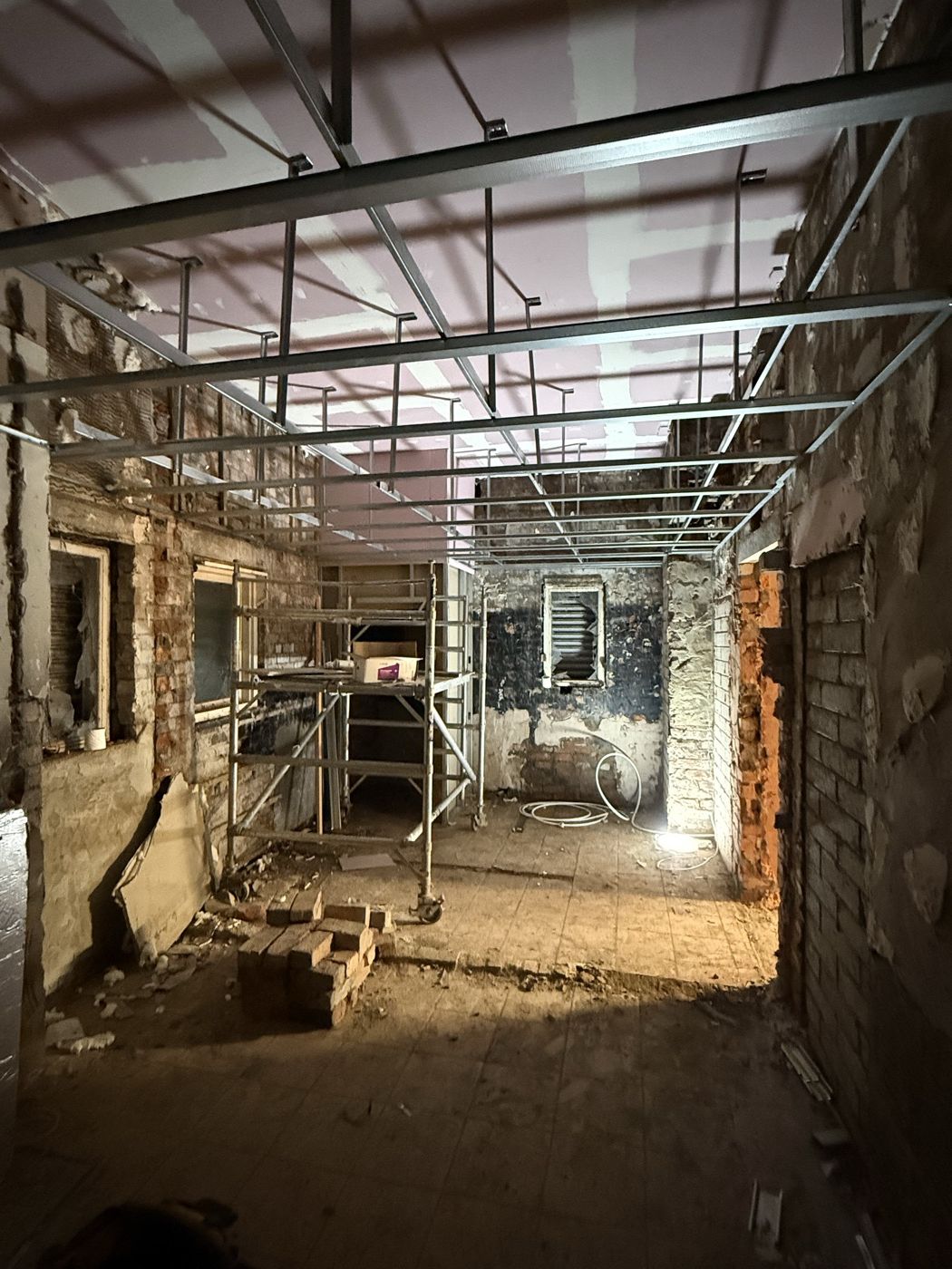 Metal-frame ceiling grid running the length of a corridor