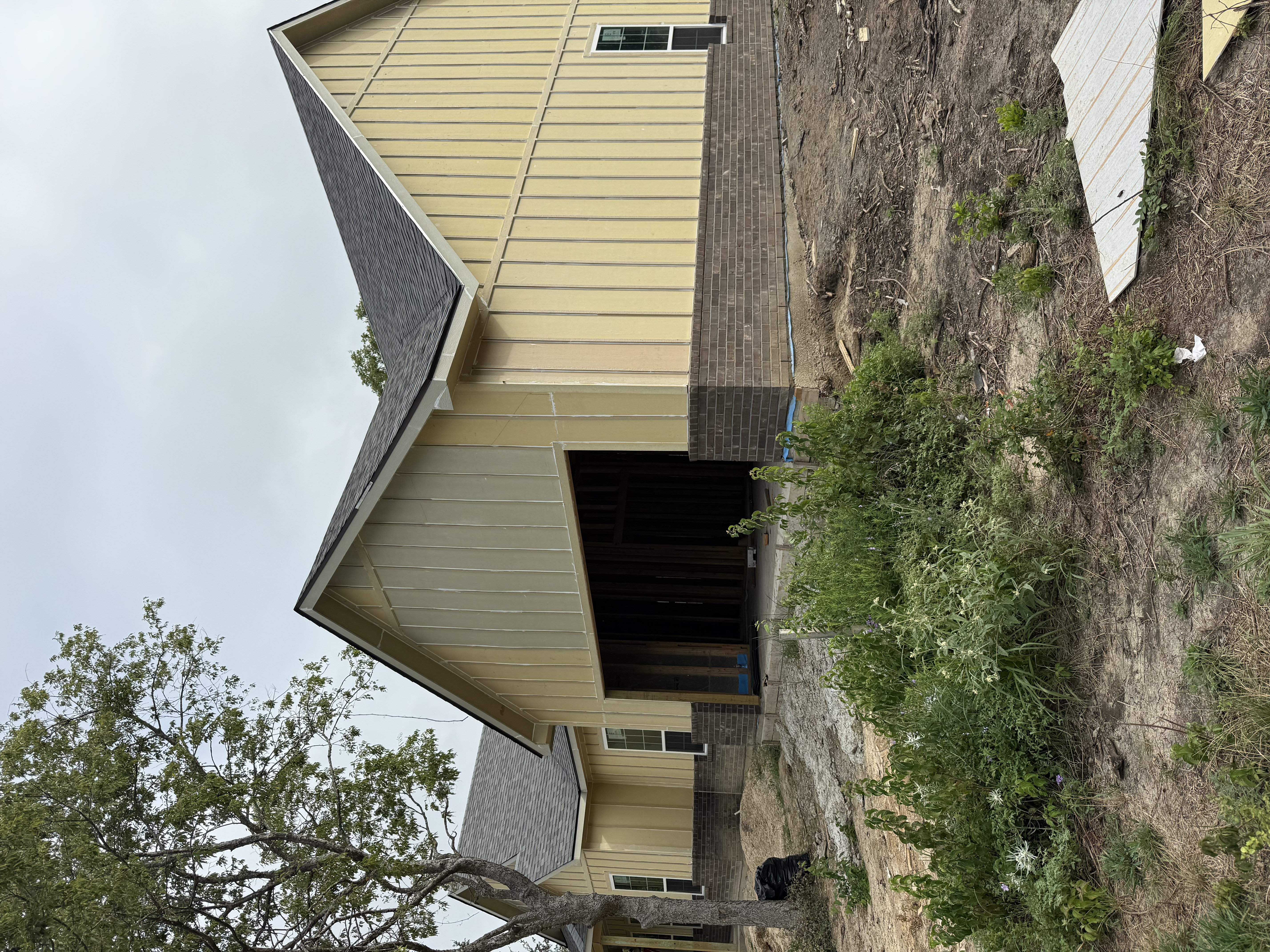 Completed remodel ‚Äî board-and-batten farmhouse exterior