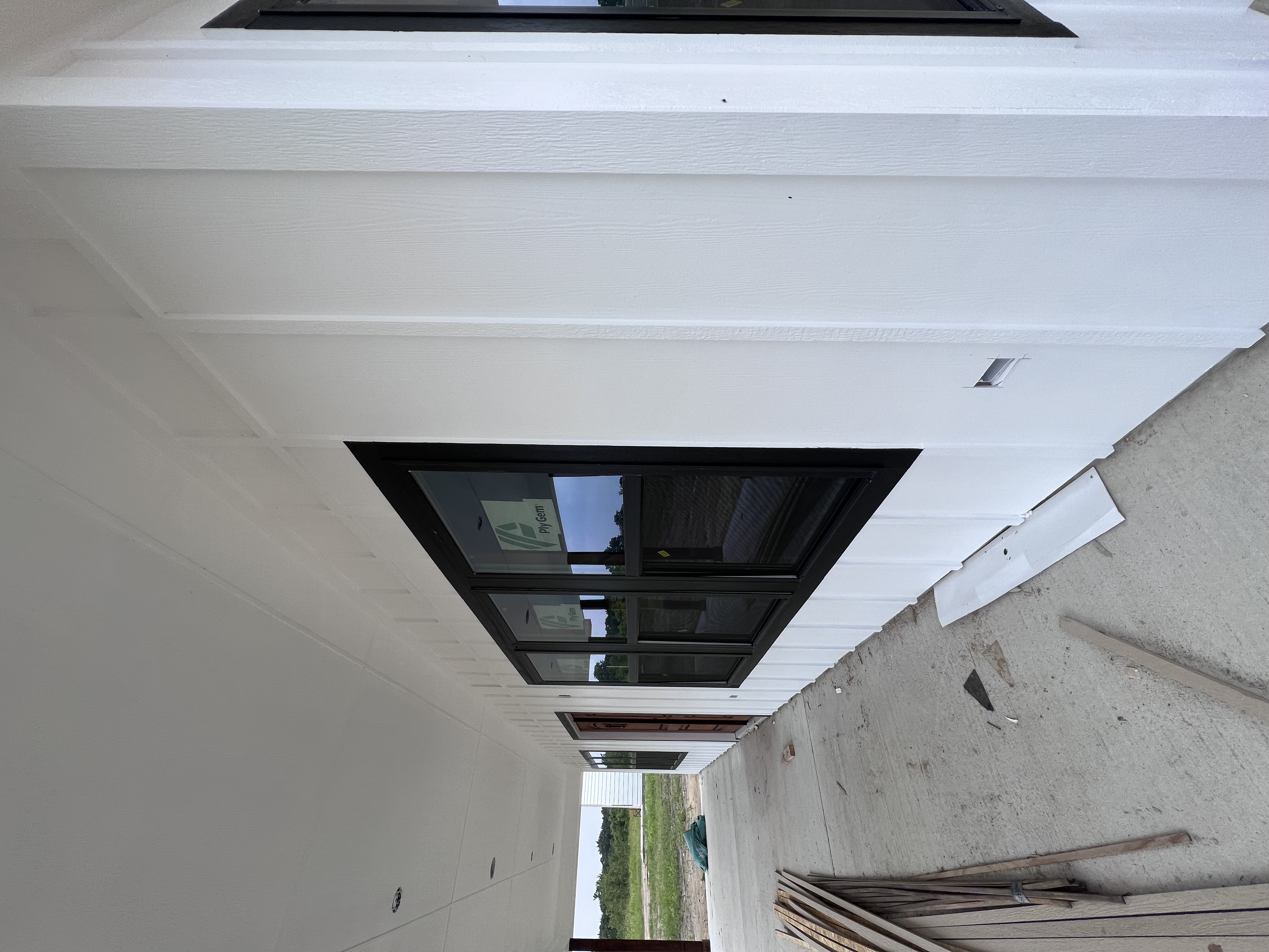 White farmhouse porch ‚Äî vertical siding and painted soffit detail