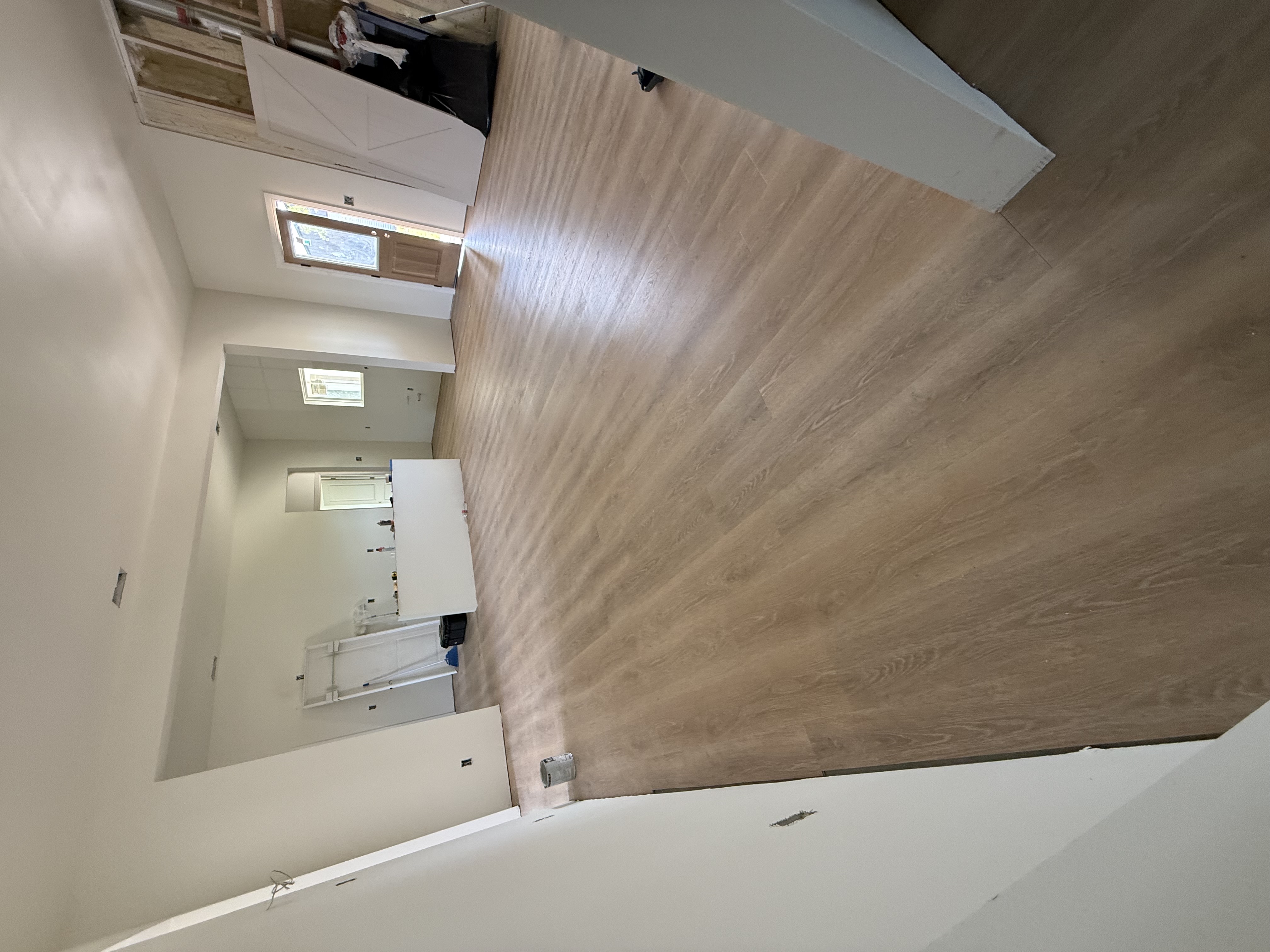 Interior build ‚Äî painted walls, wood floor install, drywall complete
