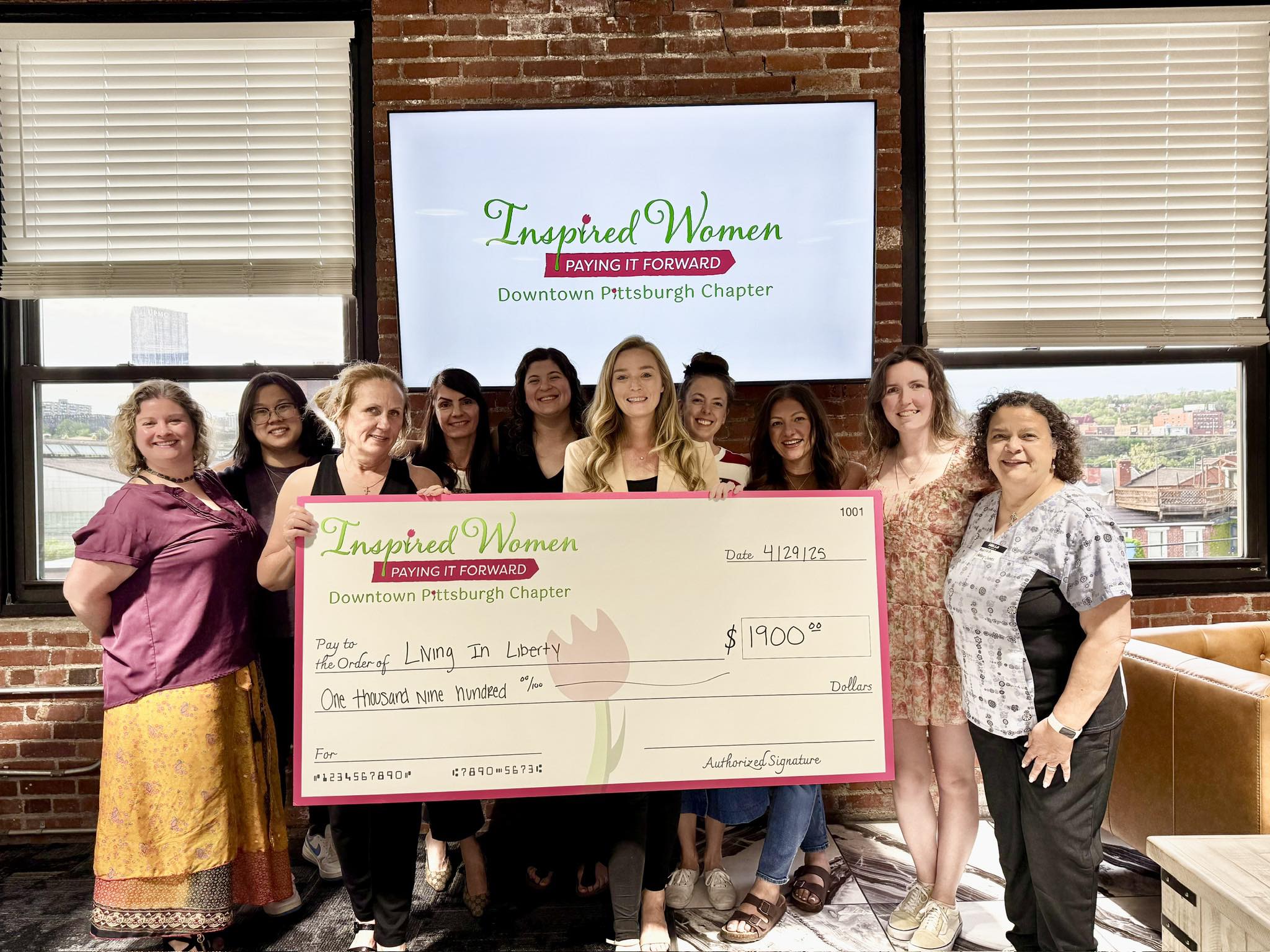 Living in Liberty receiving the ceremonial check from Inspired Women Downtown Pittsburgh members at Le Mont