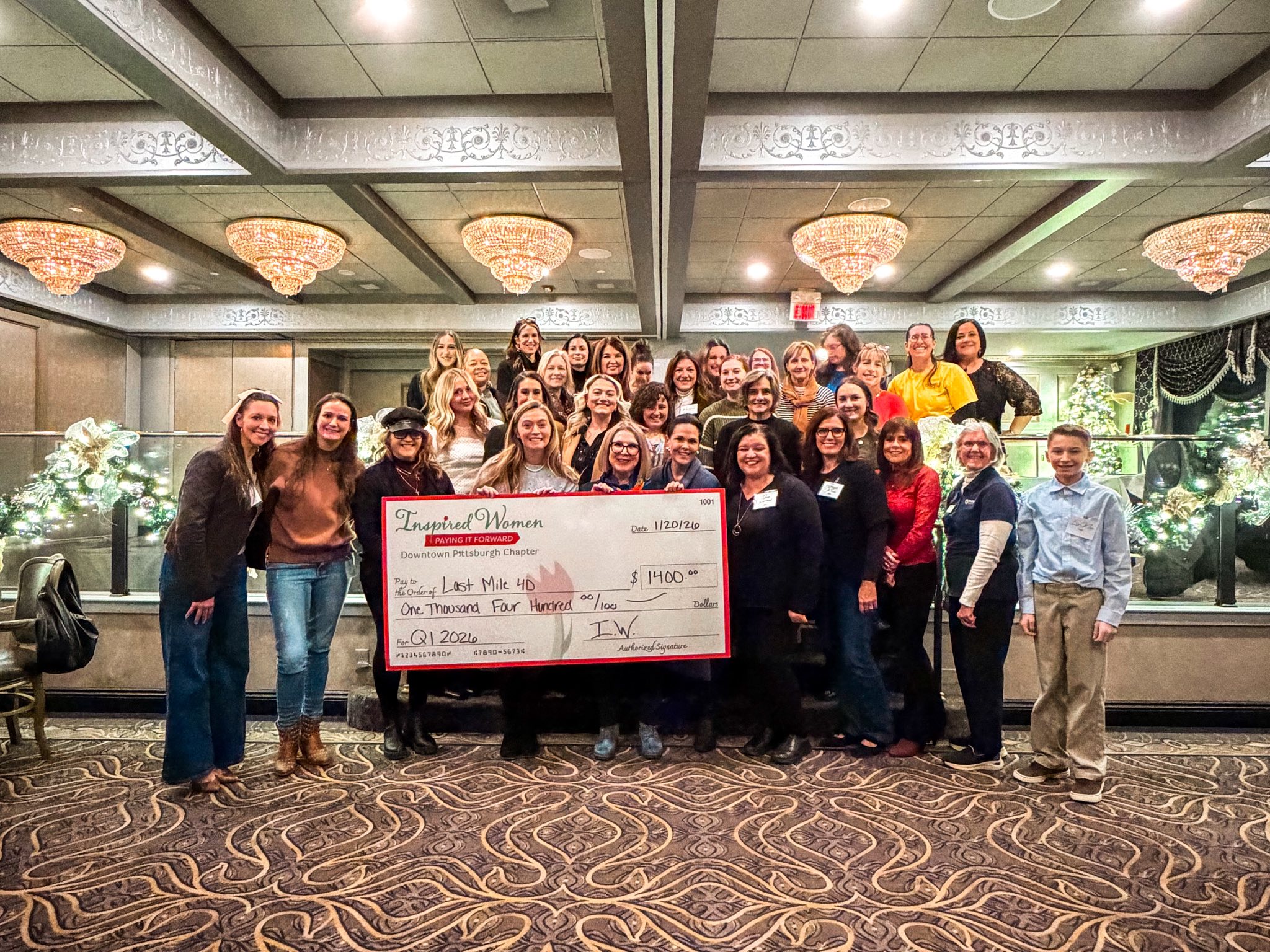 Last Mile 4D receiving the ceremonial check from Inspired Women Downtown Pittsburgh members at Le Mont