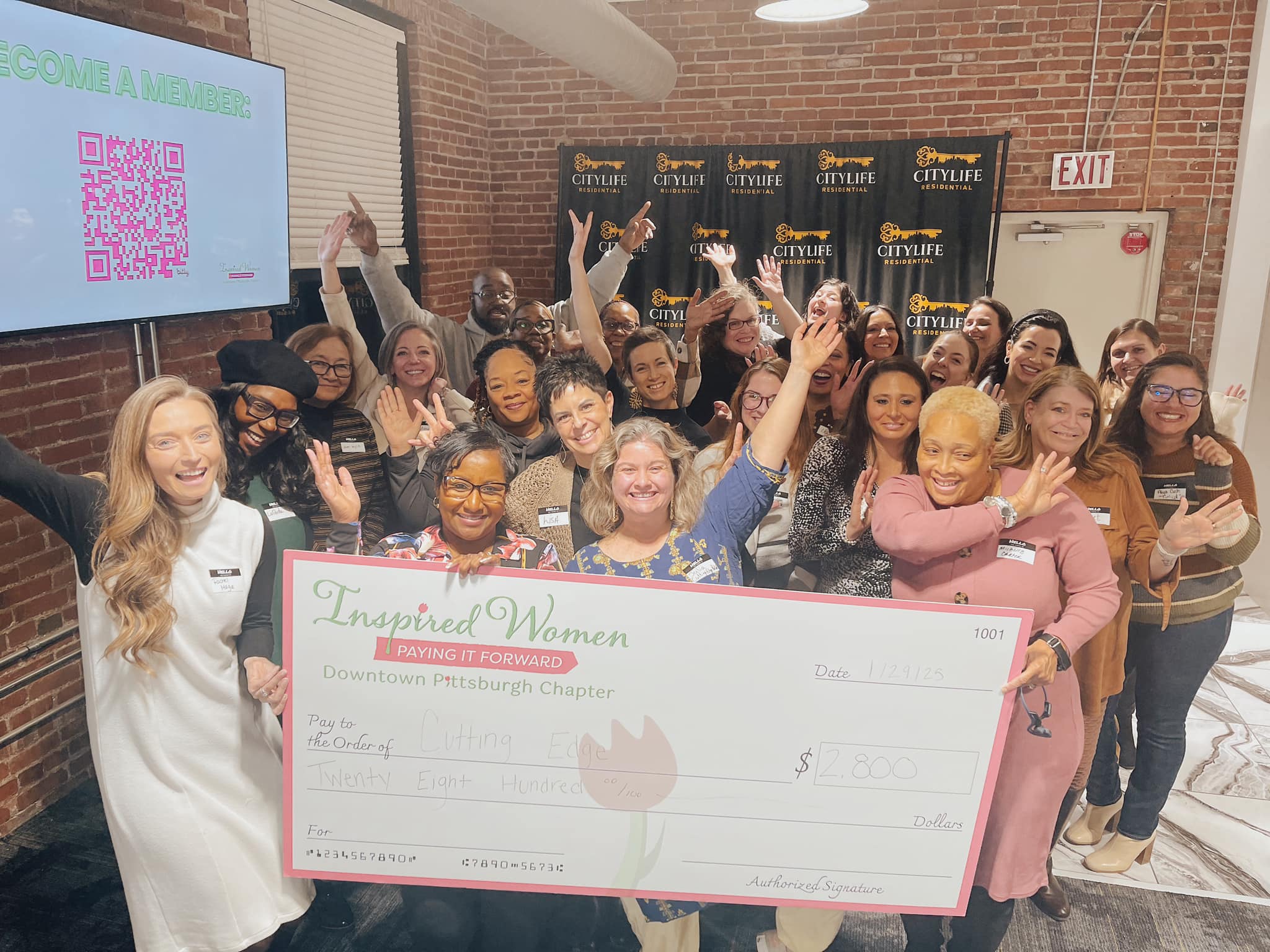 Dress for Success Pittsburgh receiving the ceremonial check from Inspired Women Downtown Pittsburgh members at Le Mont