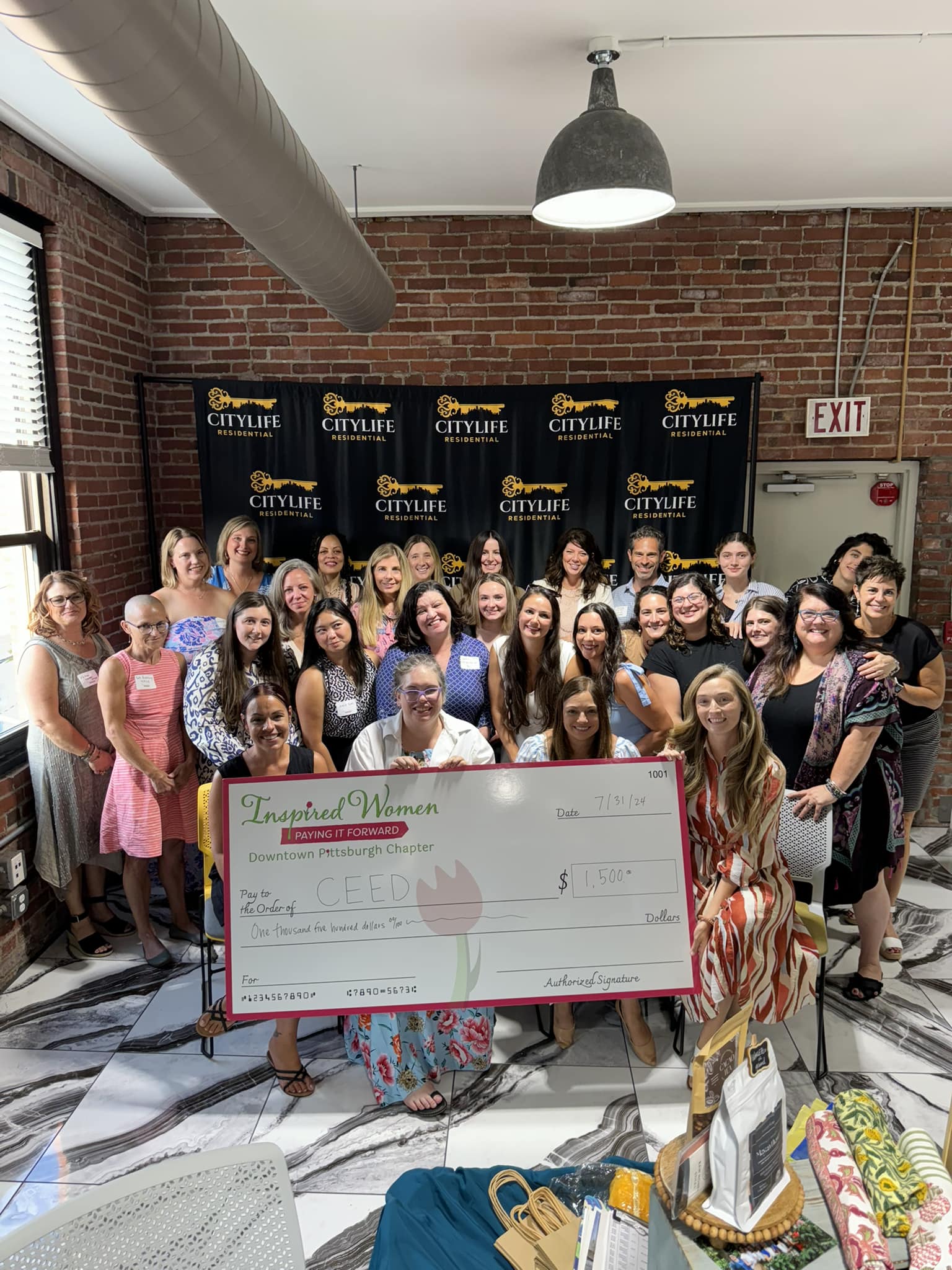 CEED Trust receiving the ceremonial check from Inspired Women Downtown Pittsburgh members at Le Mont