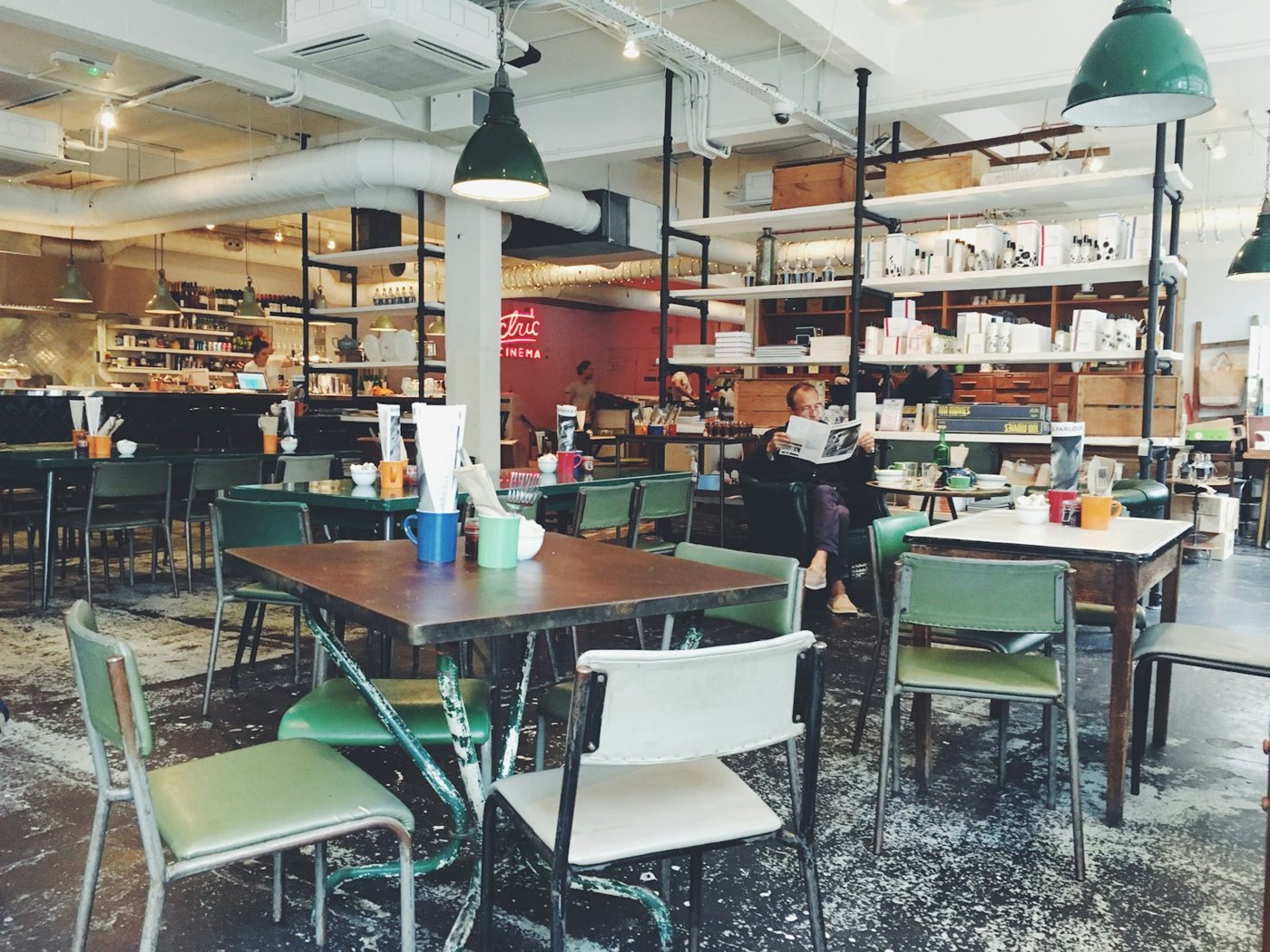 Cafe interior showing customer seating, a service counter and circulation space