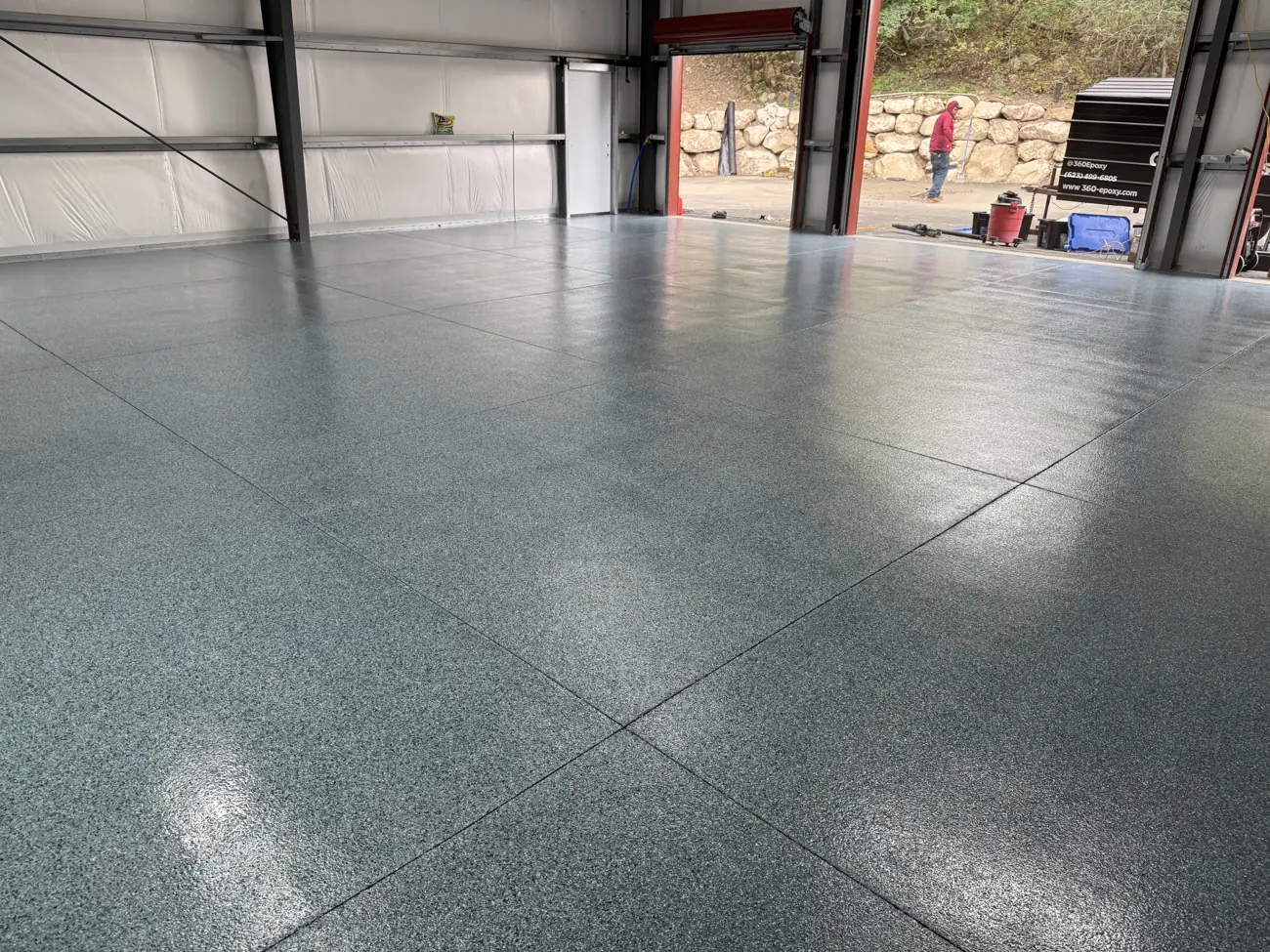 Shop floor finished in gray flake with the bay doors open