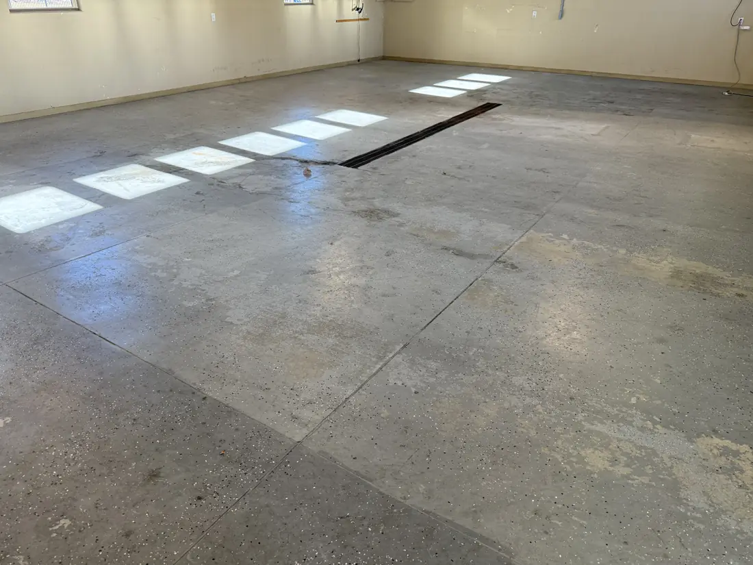 Garage before: stained, patchy concrete