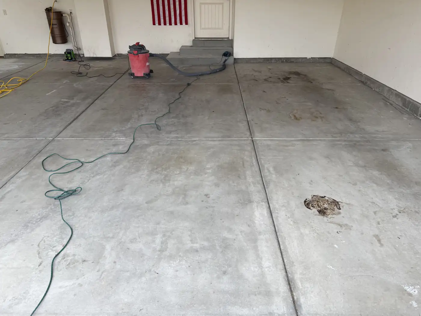 Garage before: bare, stained concrete with oil spots