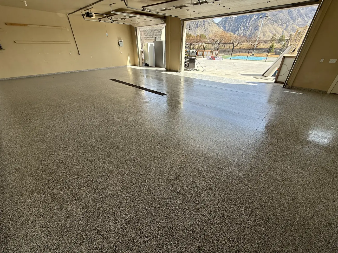 Finished flake garage floor with the door open to a mountain view