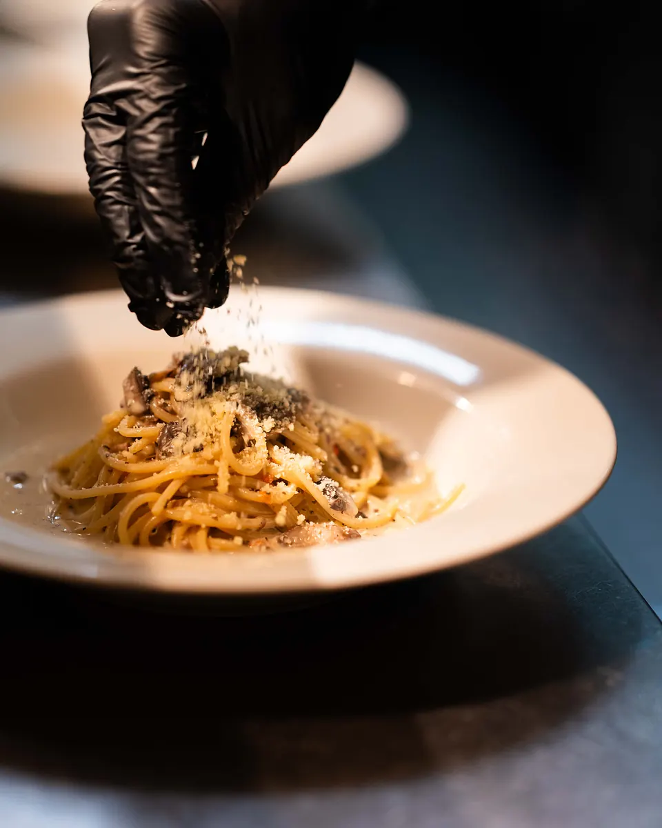 Spaghetti ai Funghi finished with grated parmigiano over the porcini, champagne and truffle sauce