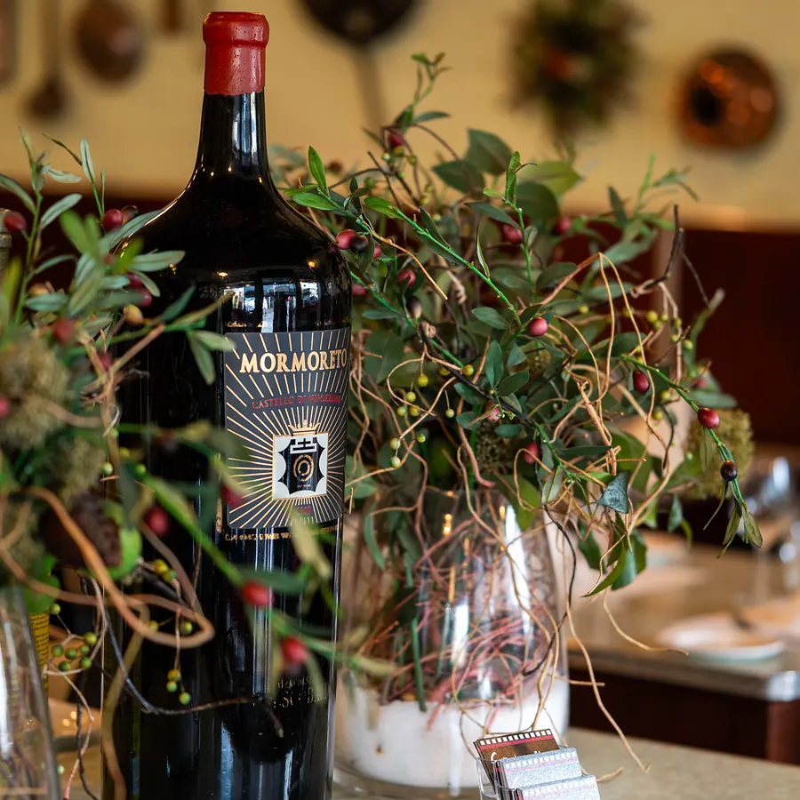 A magnum of Italian red wine among the greenery in the Grappino dining room