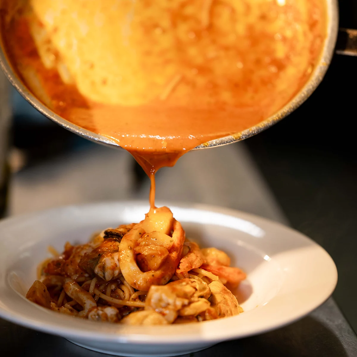 Sauce poured from the pan over Grappino's Marinara in the kitchen