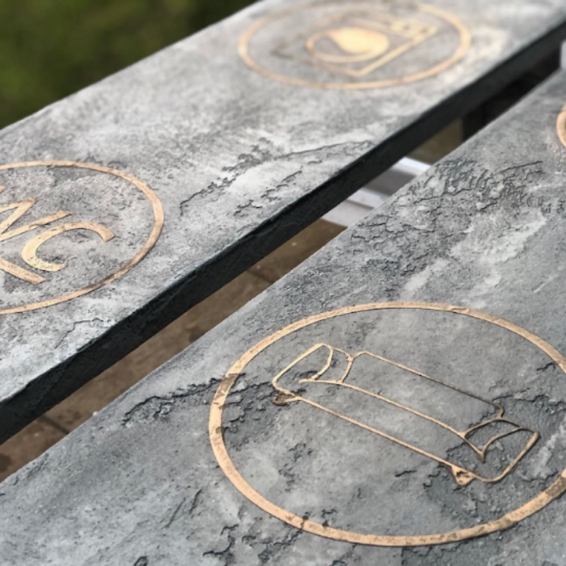Liquid metal and concrete fusion finish burnished to a metallic surface