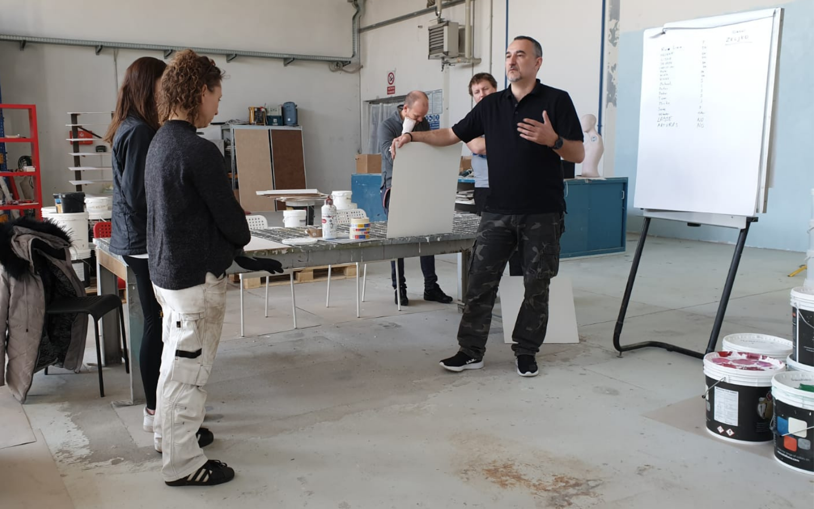 Students applying Venetian plaster to sample walls during an Italiwalls workshop in Serbia
