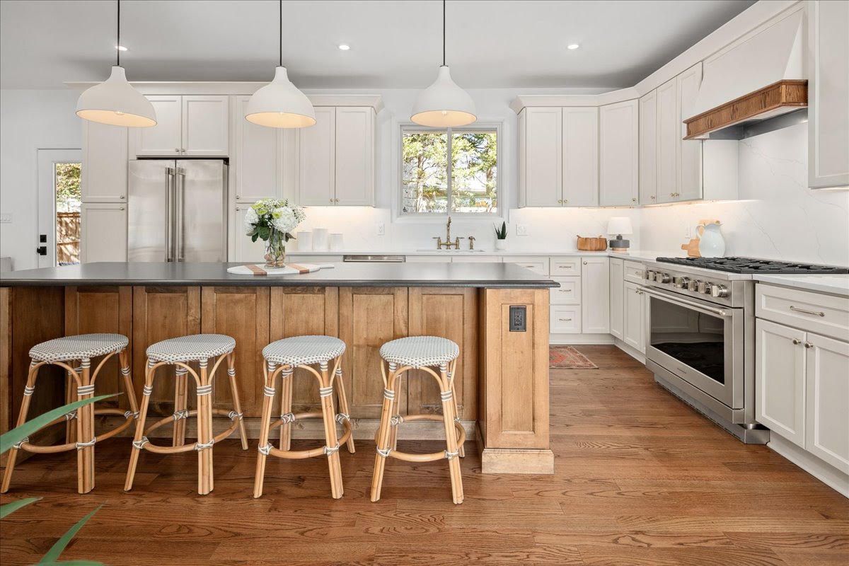 Kitchen renovated by Star Granite & Marble: quartz island countertop and white cabinetry
