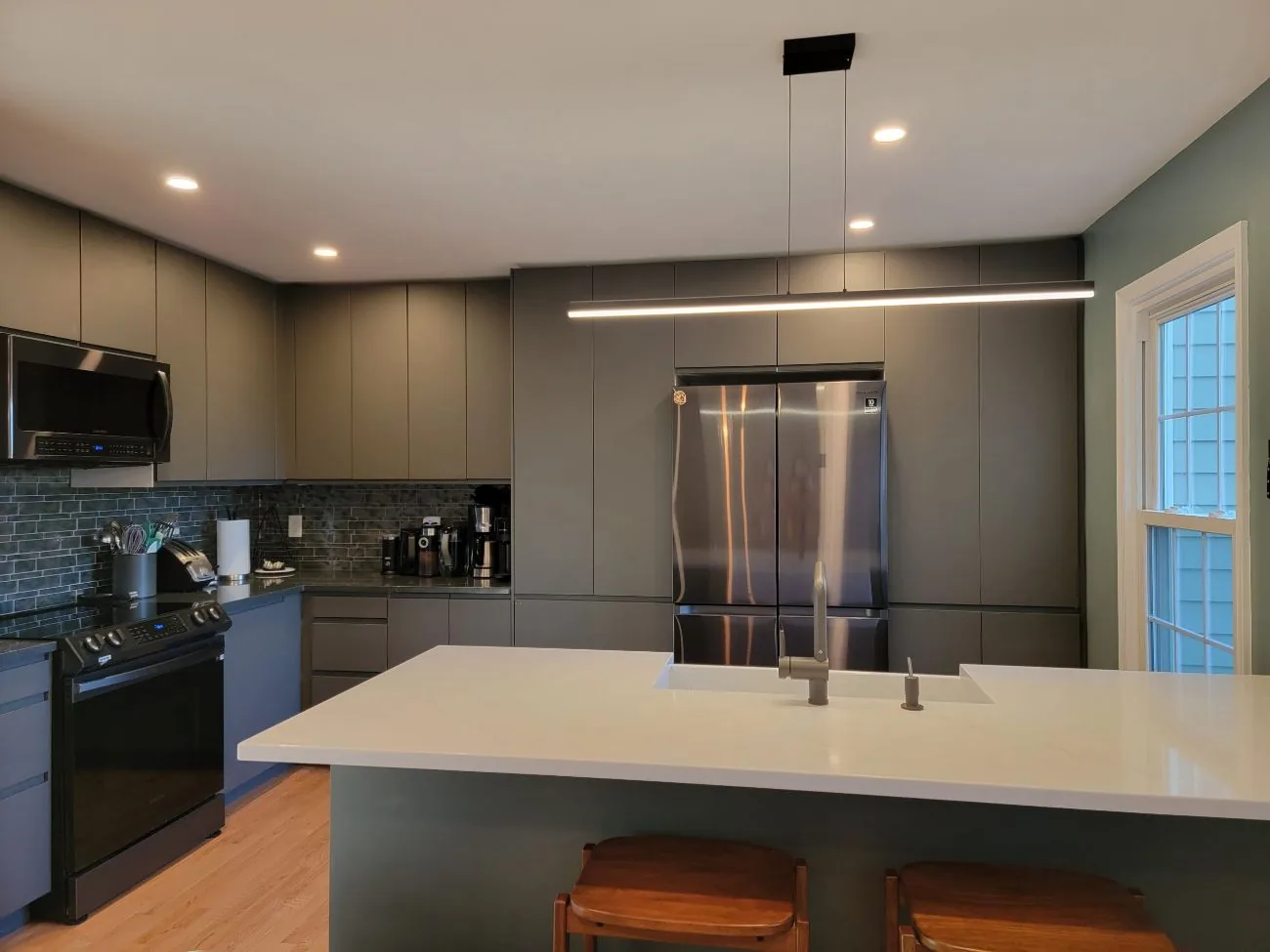 Modern gray kitchen with a white waterfall island