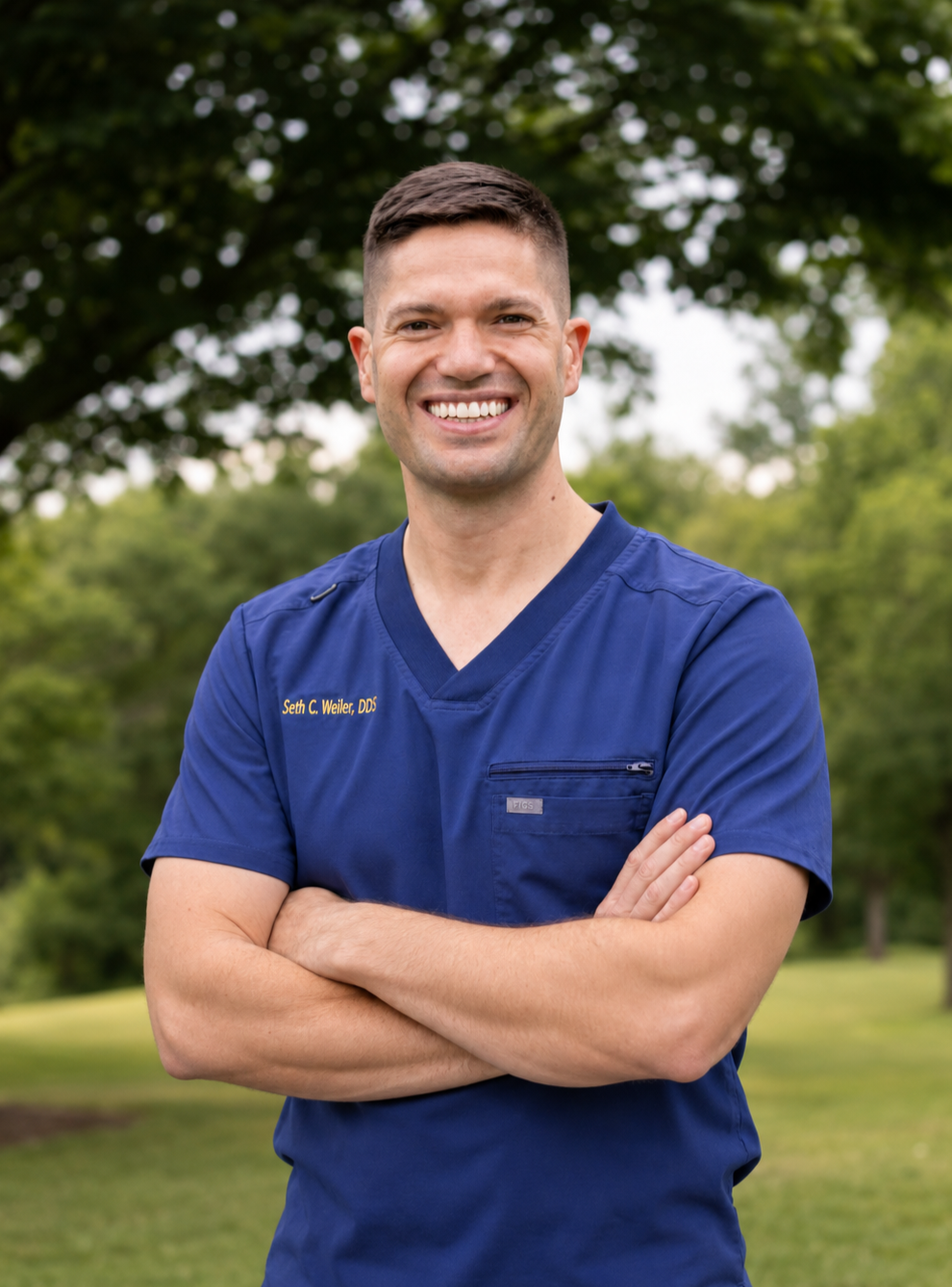 Seth Weiler, DDS smiling with arms crossed in the Magnolia Implants & General Dentistry office
