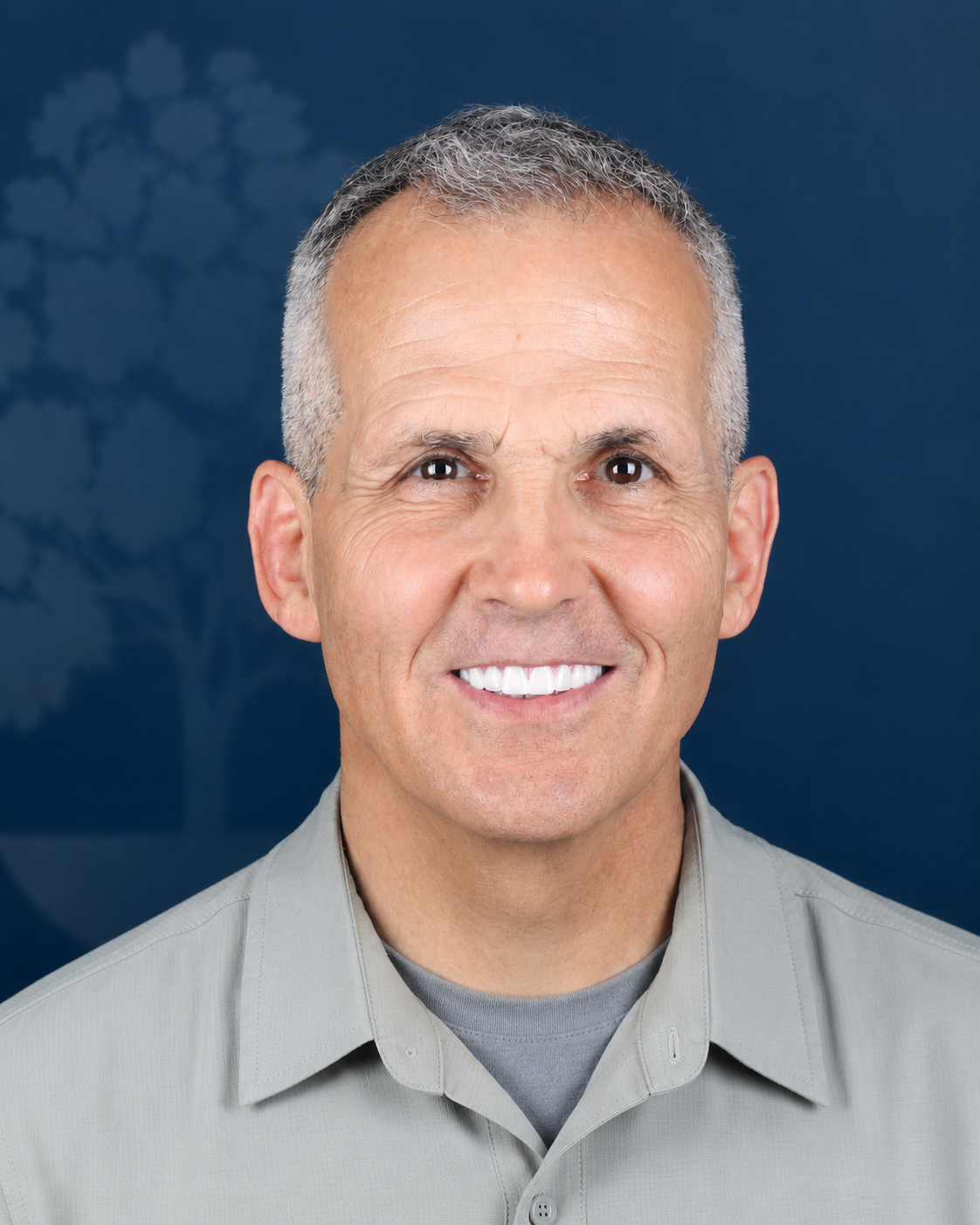 Smiling patient with gray hair, portrait after dental implant treatment