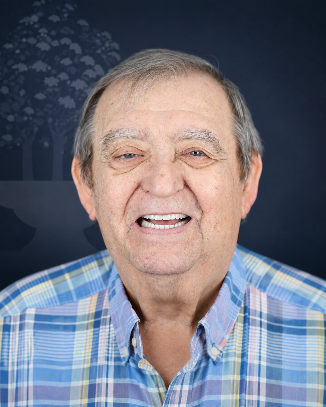 Smiling patient in a plaid shirt, portrait after dental implant treatment