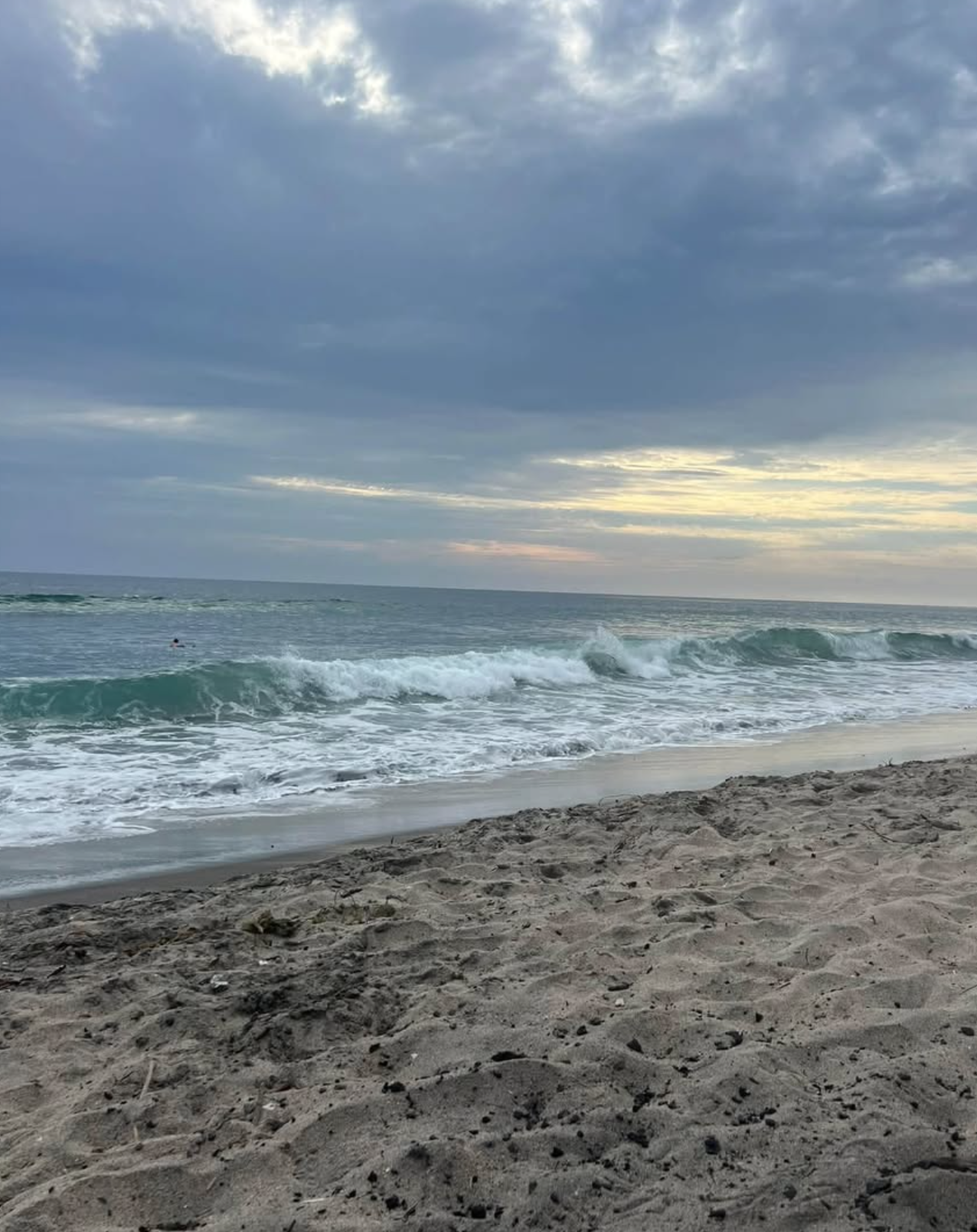 Waves rolling onto the sand at dusk in Encinitas