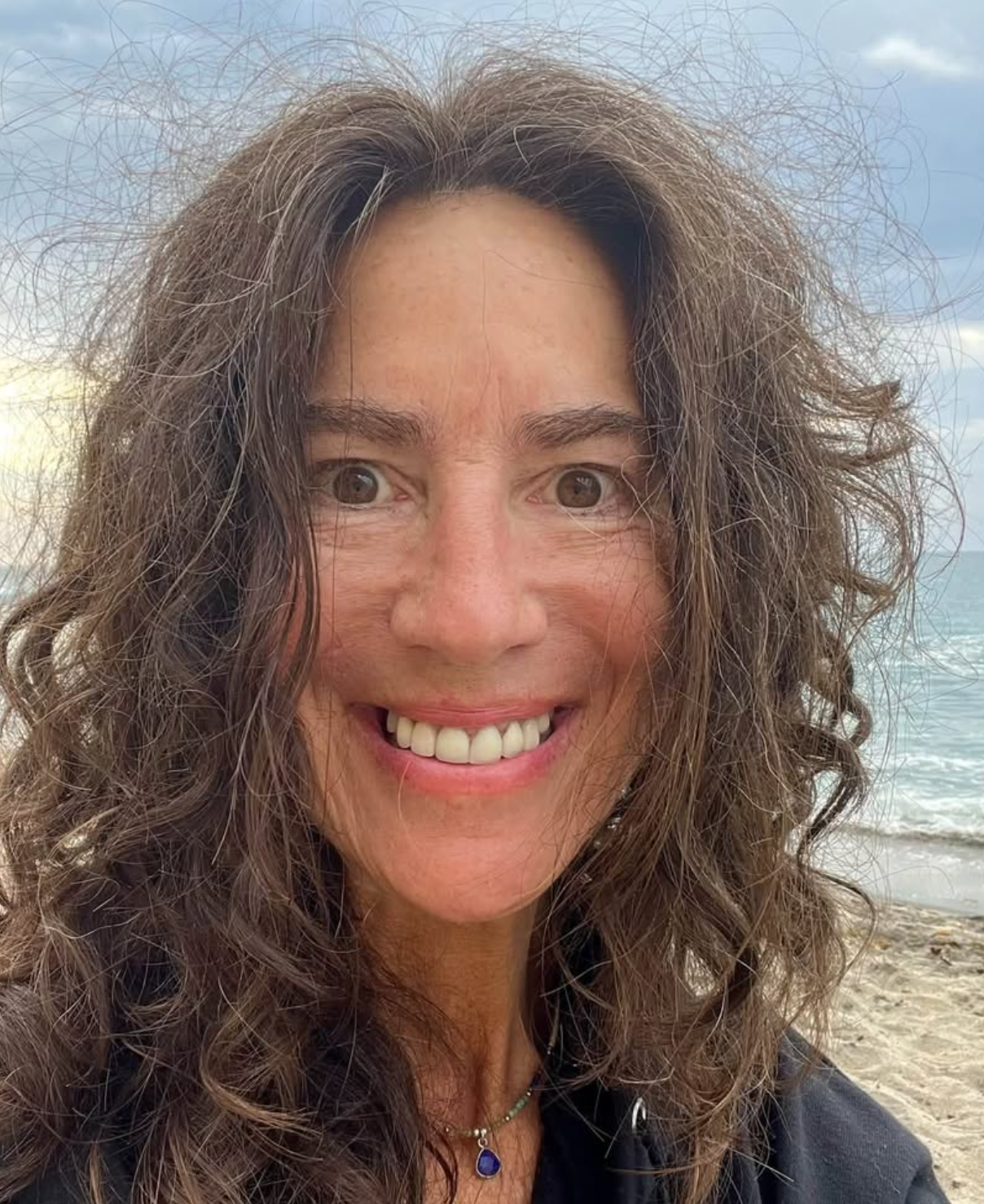 Paula Barkmeier smiling on the beach in Encinitas