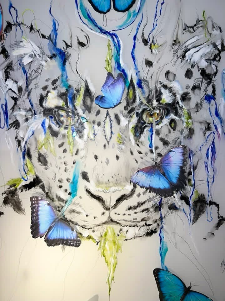 Snow leopard with blue morpho butterflies