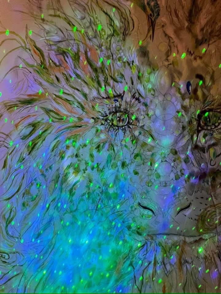 Lion drawing scattered with glowing green and blue points of light