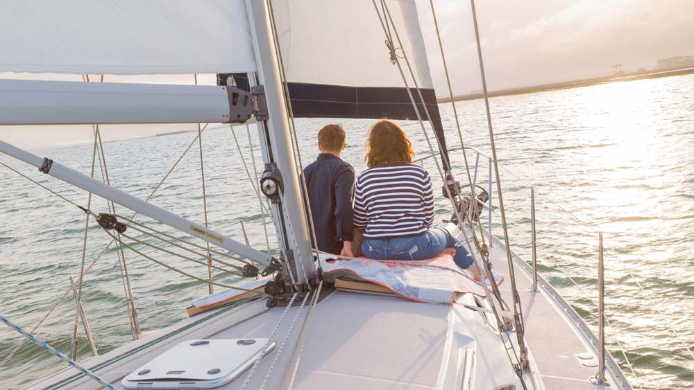 Couple enjoying scenic sailing views during a private sailing charter near Folly Beach South Carolina Couple enjoying scenic sailing views during a private sailing charter near Folly Beach South Carolina
