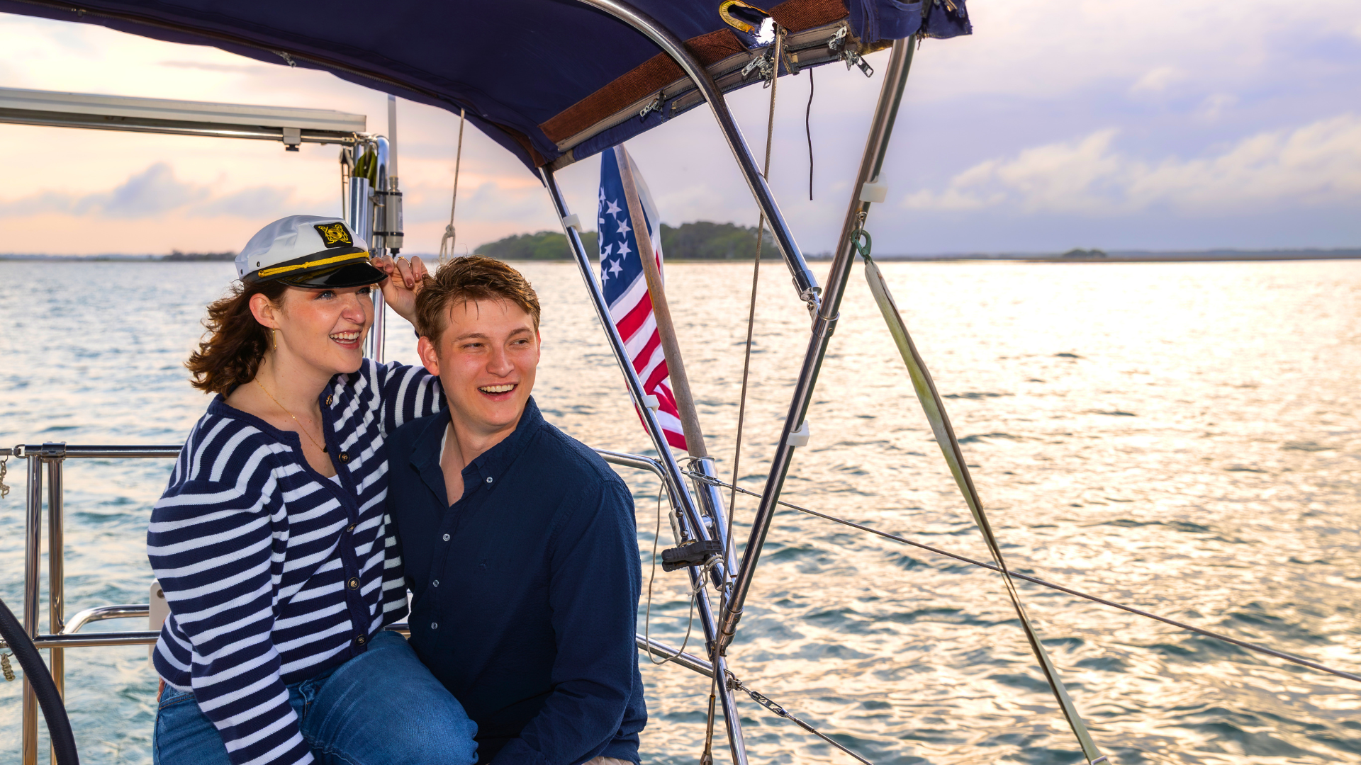 Couple enjoying a private sailing charter in Folly Beach SC during sunset with peaceful ocean surroundings
