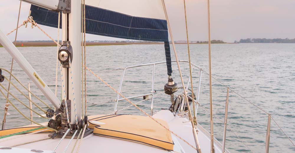View from a Folly Beach sailing charter toward saltmarsh water and Charleston skyline View from a Folly Beach sailing charter toward saltmarsh water and Charleston skyline