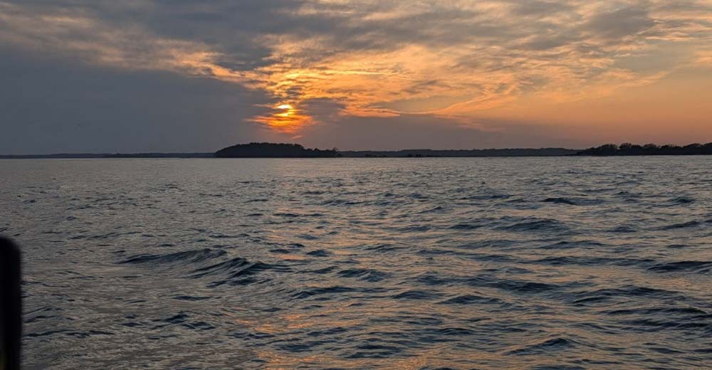 Sunset sailing in Folly Beach with calm September water and gentle wind Sunset sailing in Folly Beach with calm September water and gentle wind