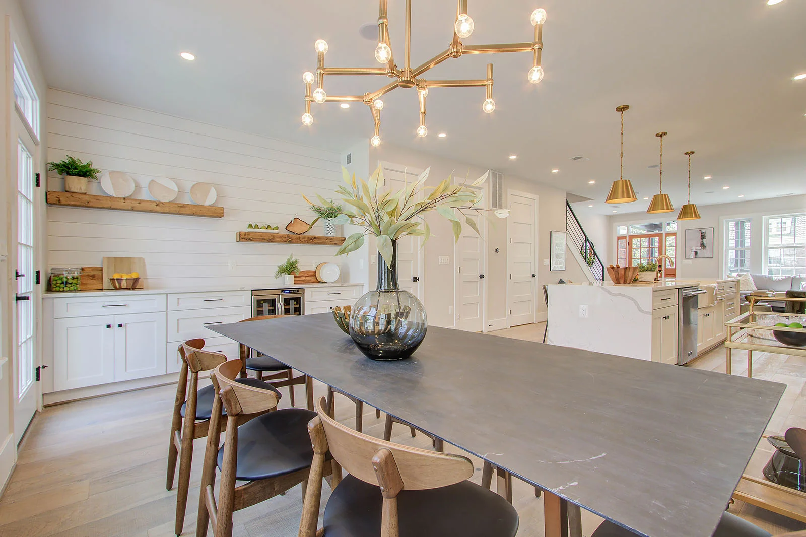Modern RemodelX kitchen remodel with stylish dining area and unique lighting fixture