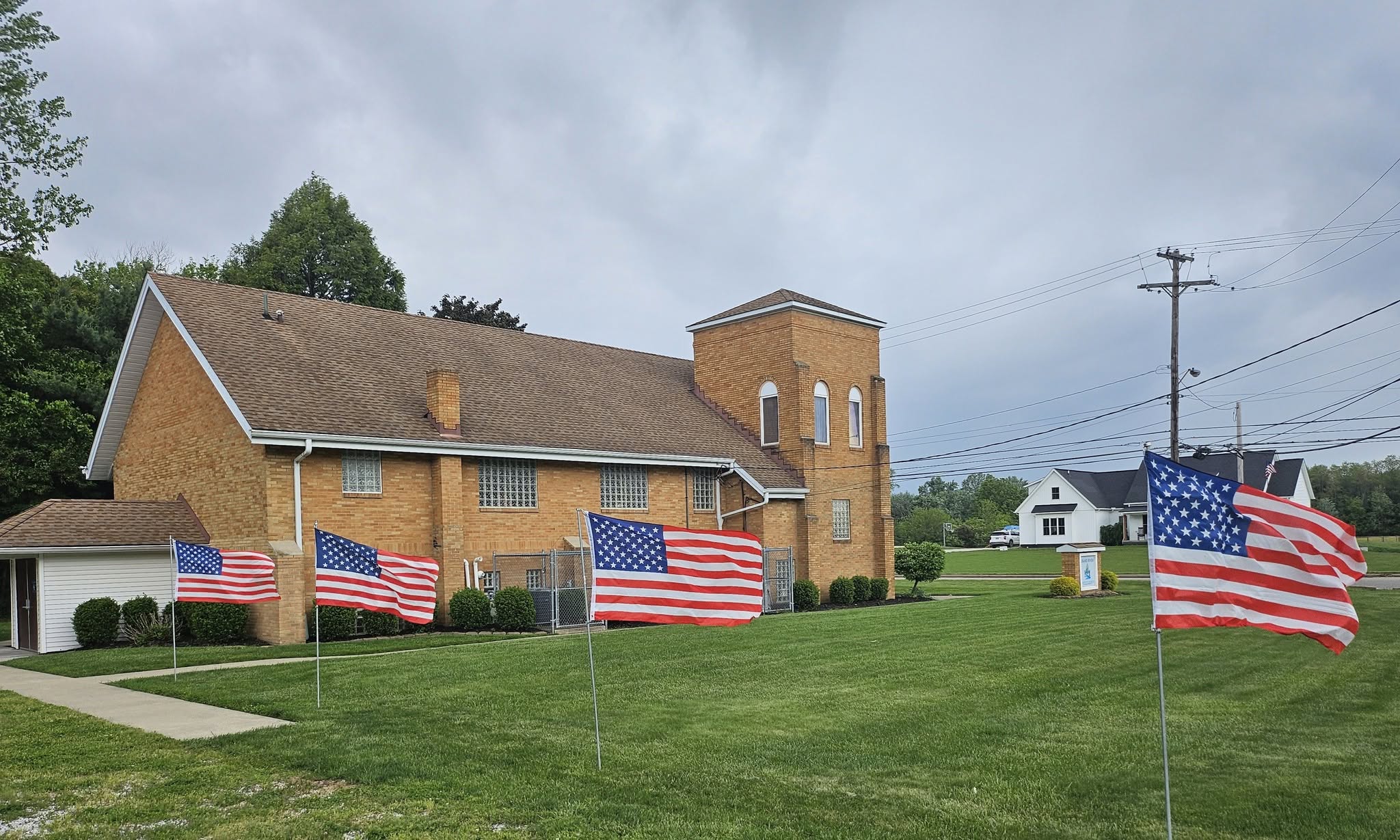 American flags flying upright outside Grand River Baptist Church